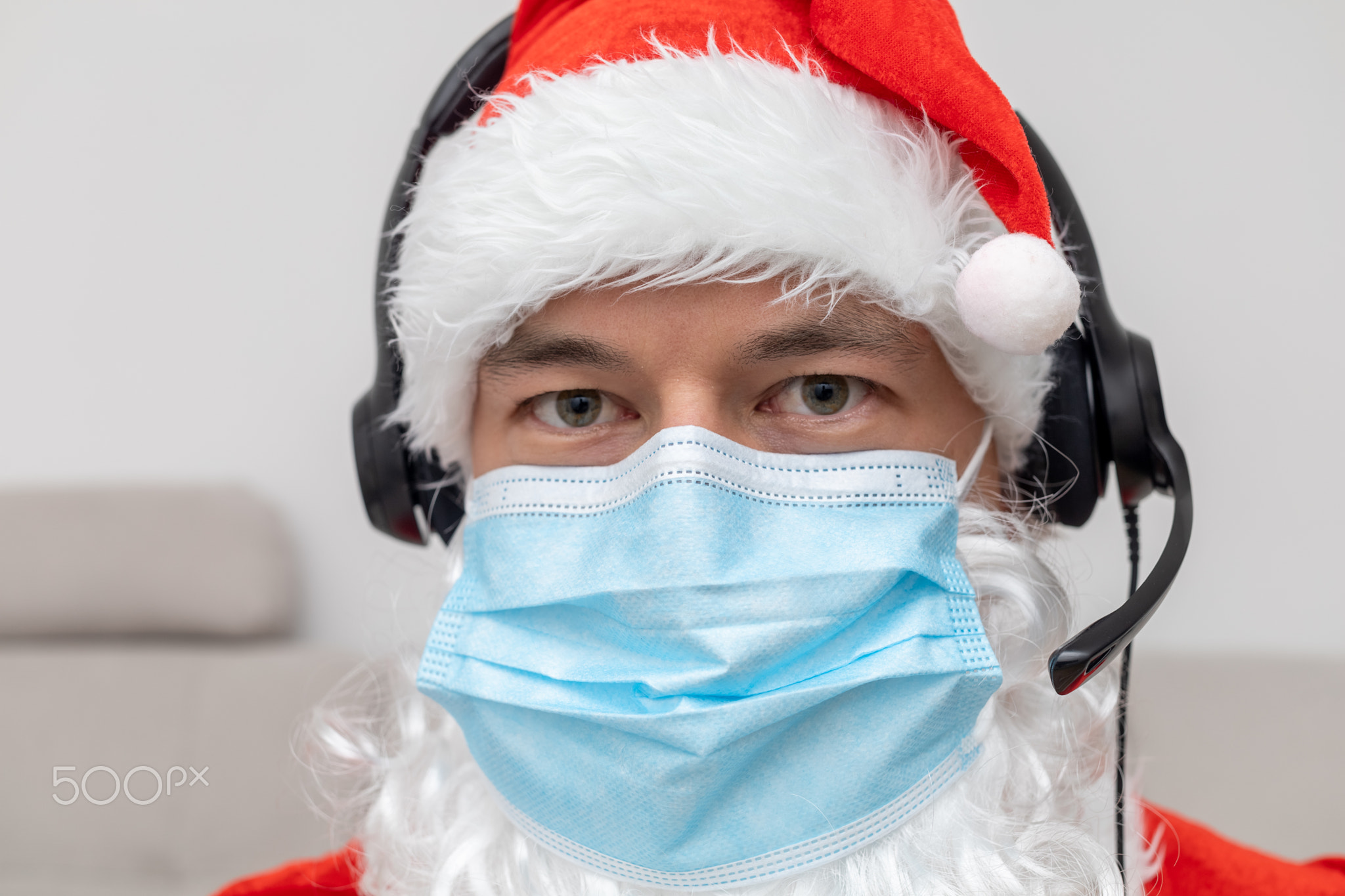 man dressed as Santa Claus in headphones