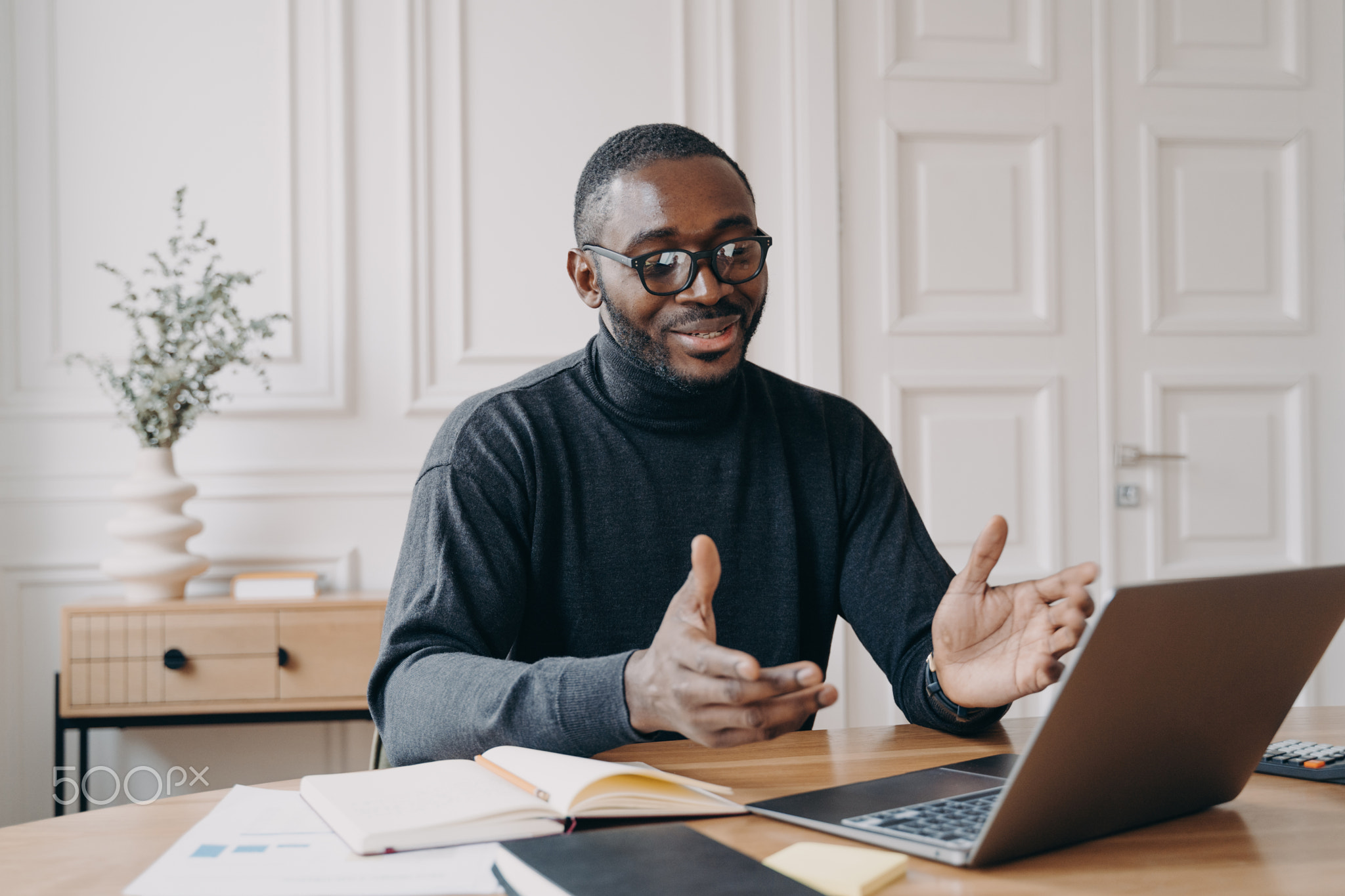 African american businessman in glasses enjoying video call on laptop