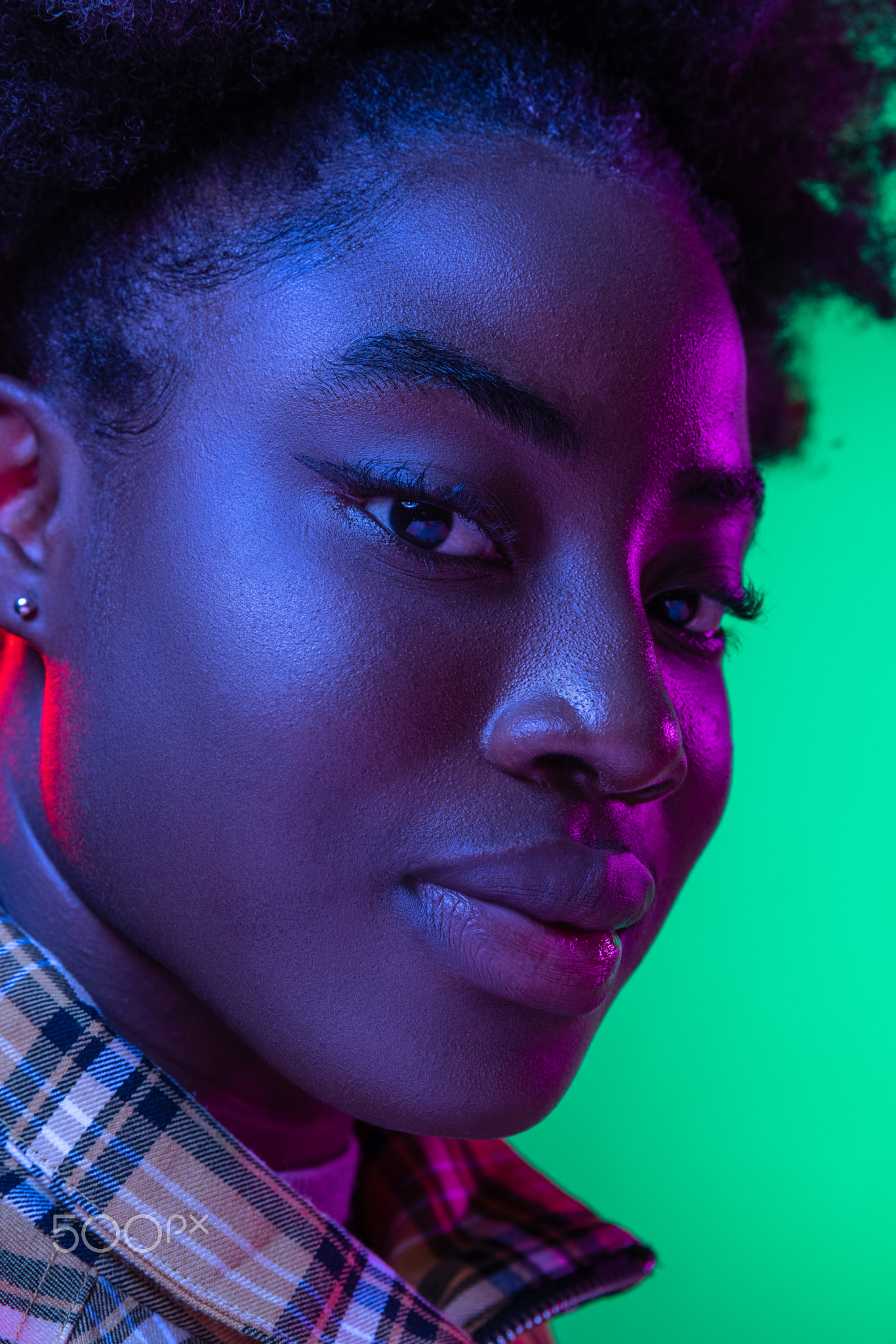 Close-up face of dark skinned young girl looking at camera isolated on