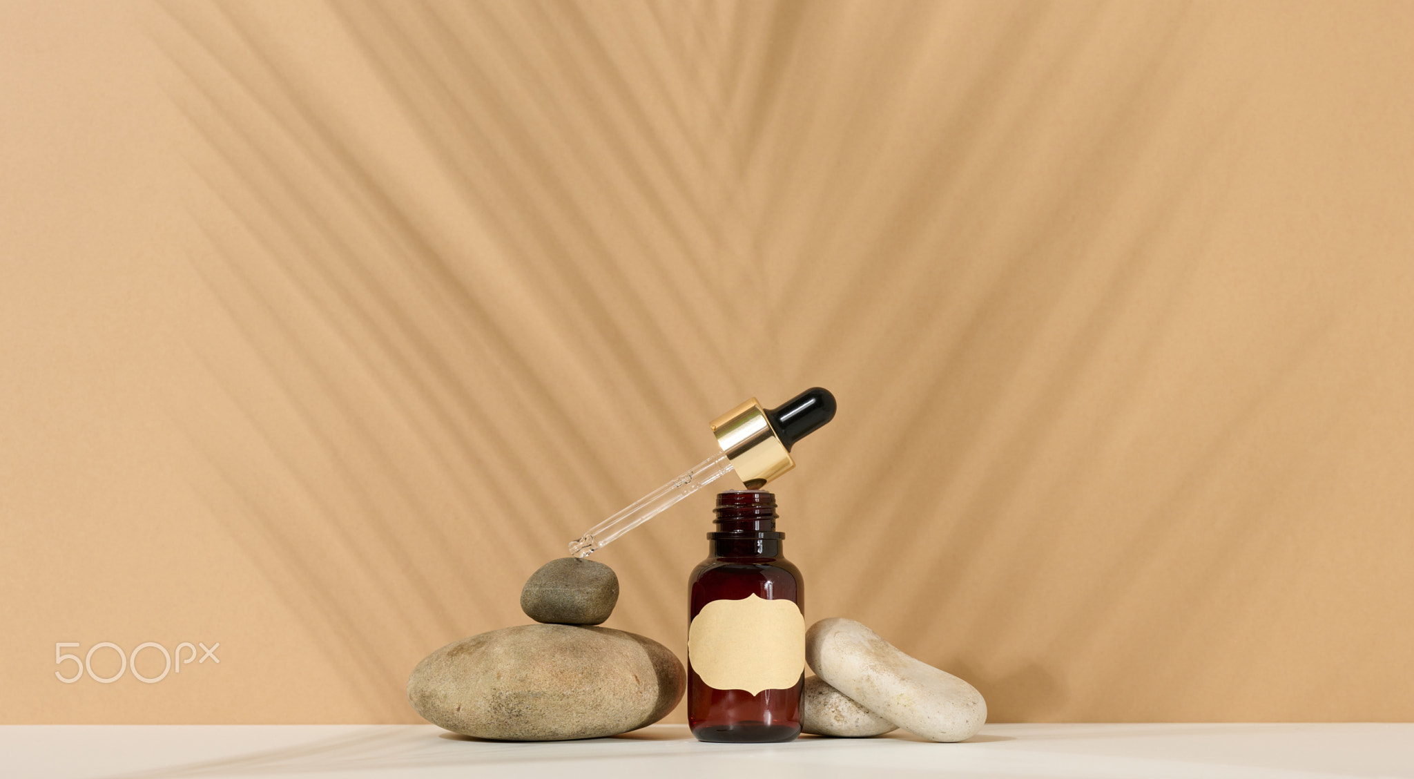 a brown glass bottle with a pipette