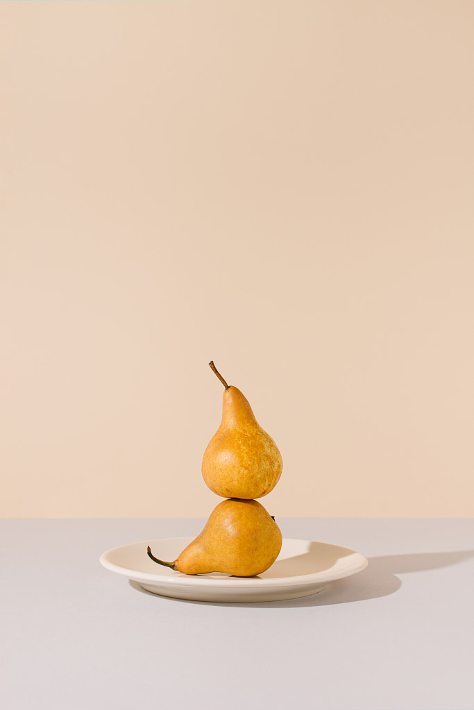 Yellow pears balancing on a ceramic plate by Ilija Perkovic on 500px.com