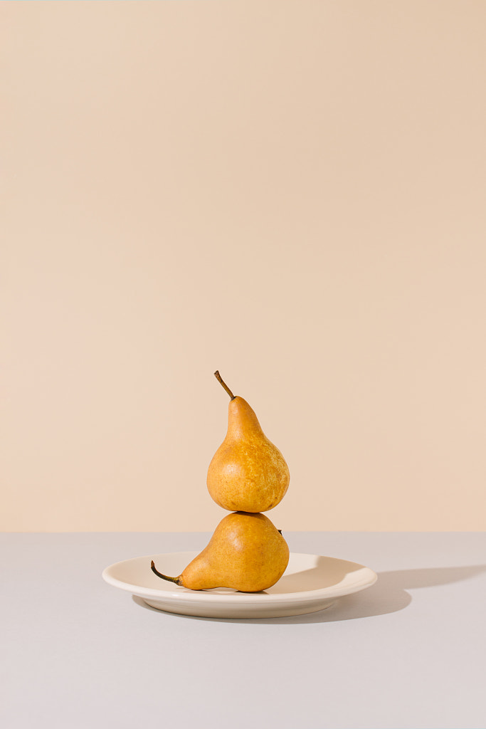 Yellow pears balancing on a ceramic plate  by Ilija Perkovic on 500px.com