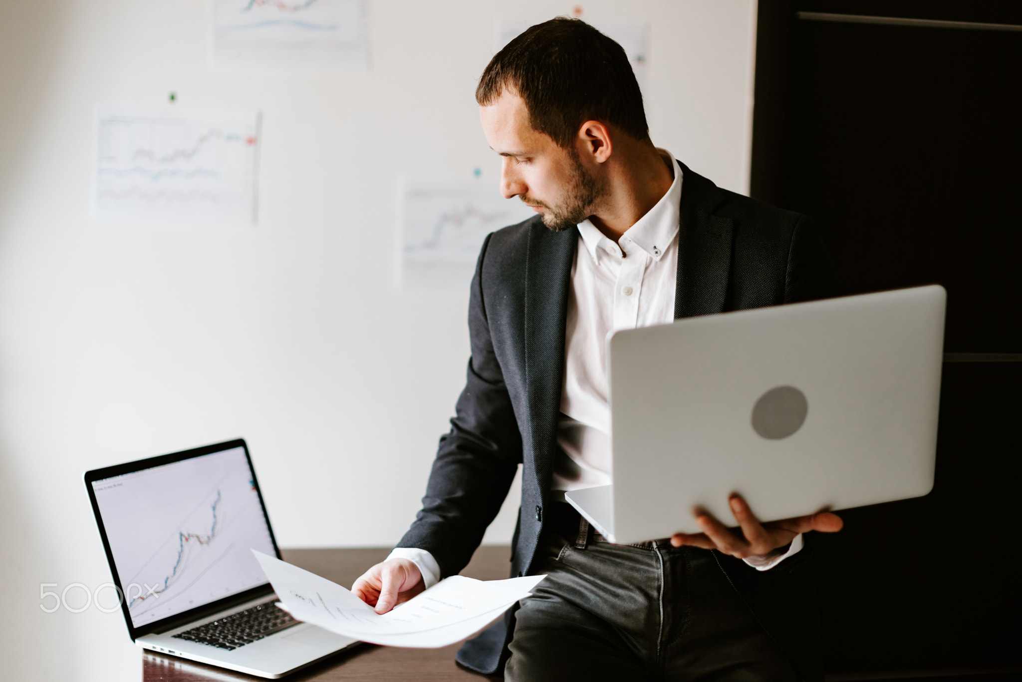 concentrated businessman working on laptop in office