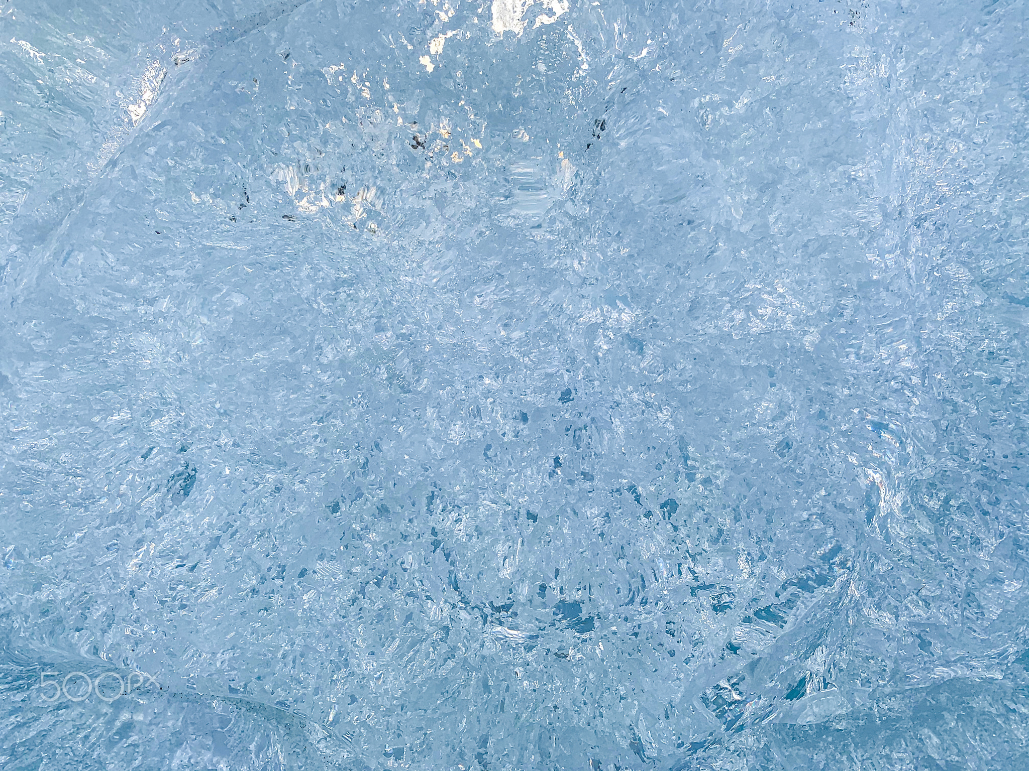 Blue ice with transparent elements and turquoise shadows.