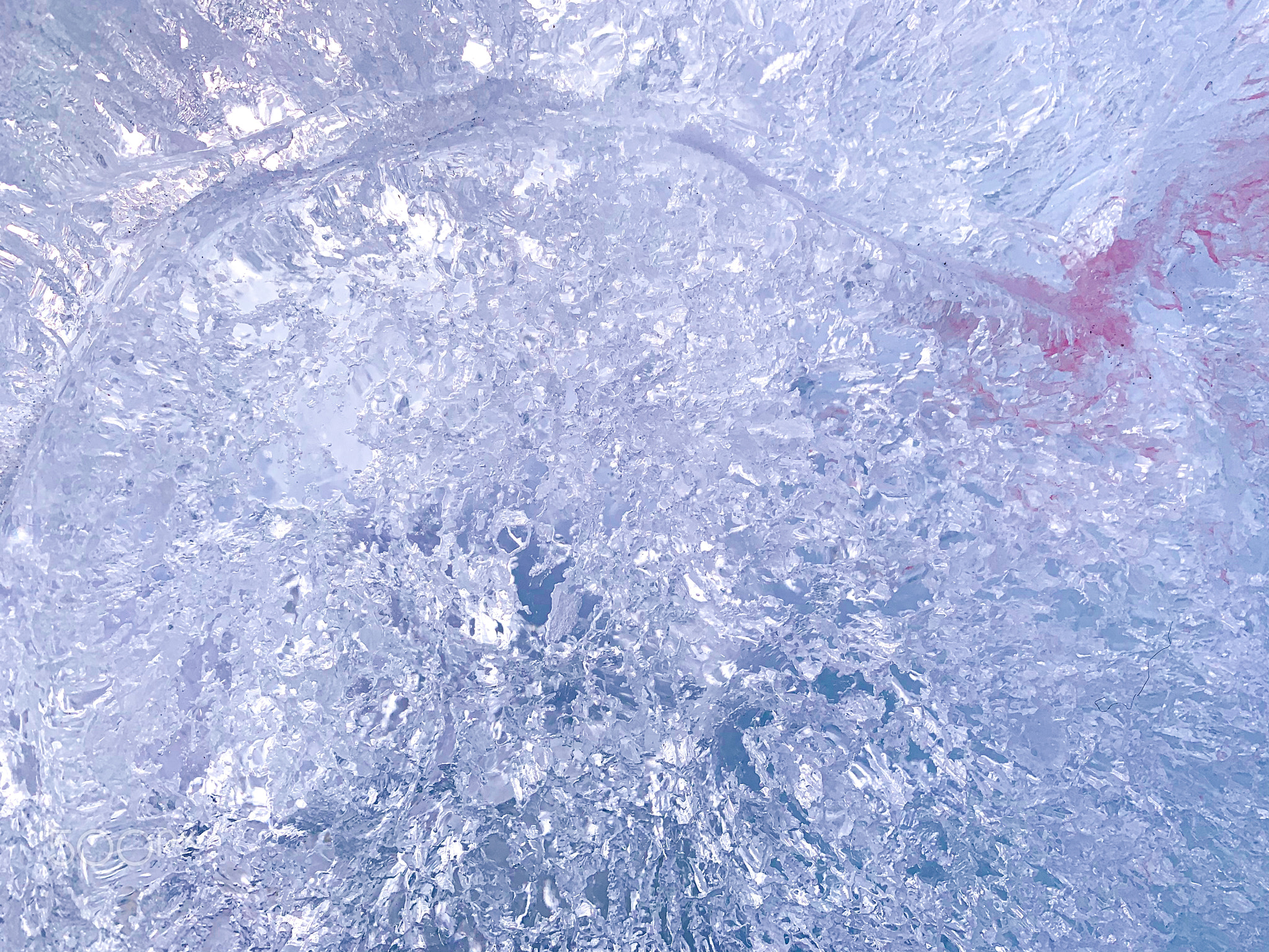 Purple blue ice with a crimson spot.