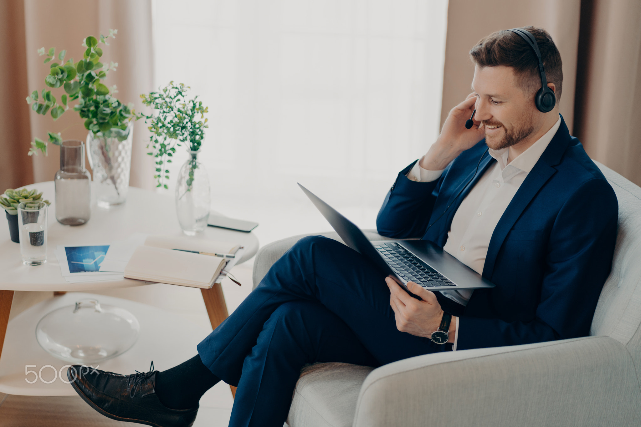 Male focused at laptop develops growth strategy makes video call