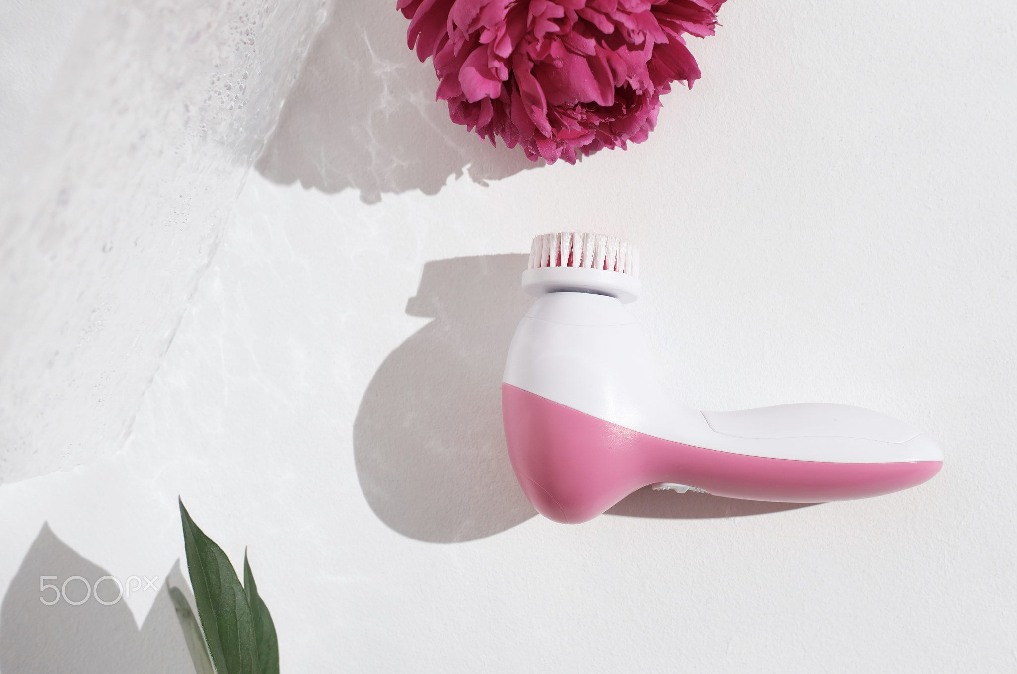 pink facial cleansing brush. Cosmetic tool for face care, scrubbing