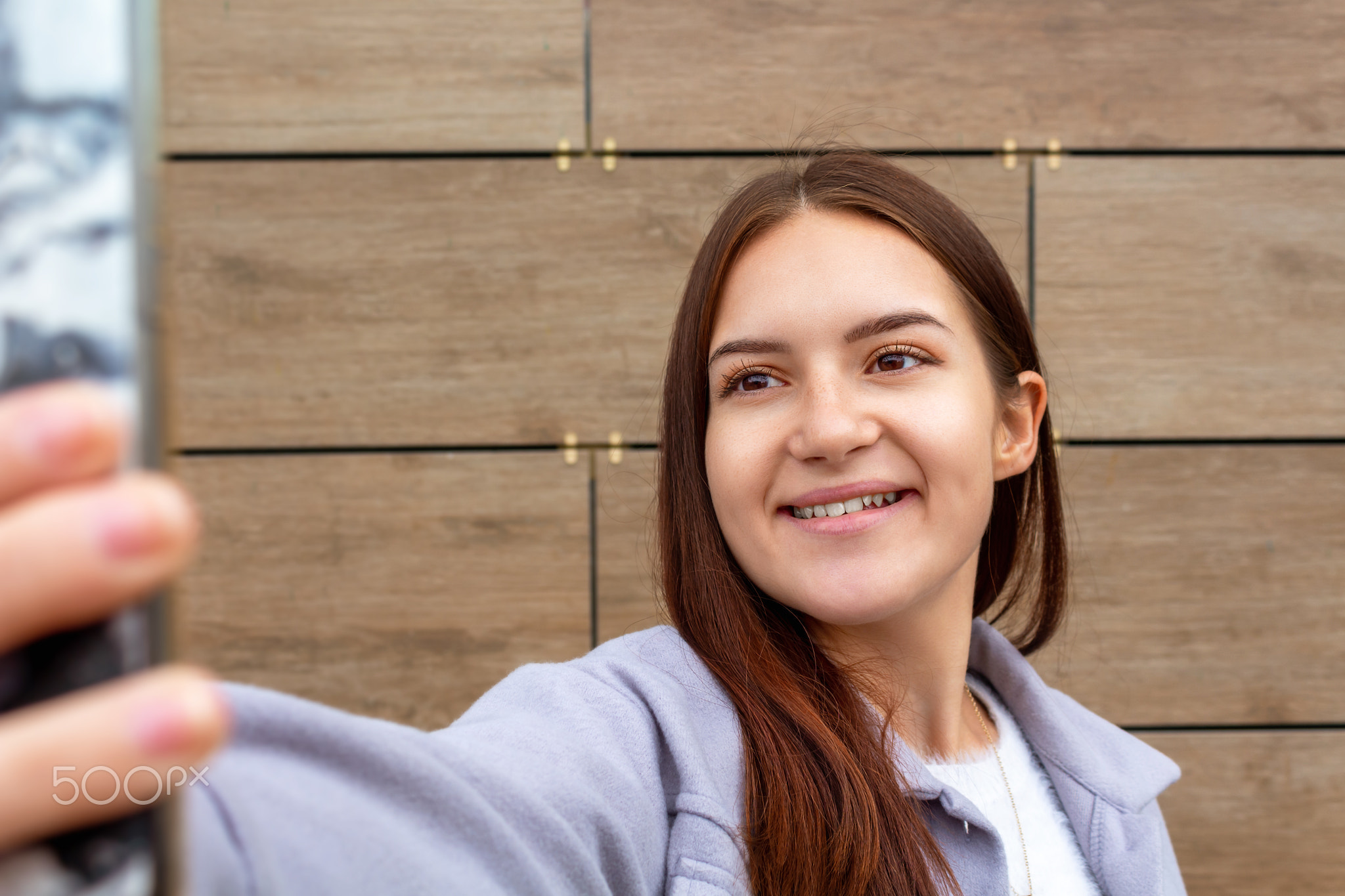 Young woman making selfie with mobile phone.