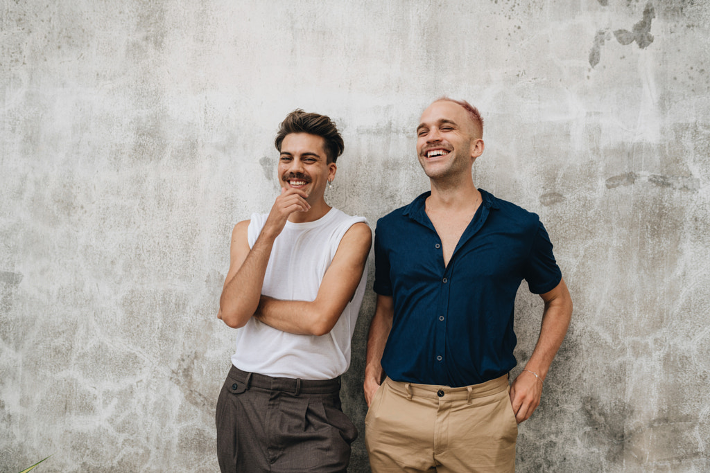 Gay Couple standing at a wall outdoors by Natalie Zotova on 500px.com