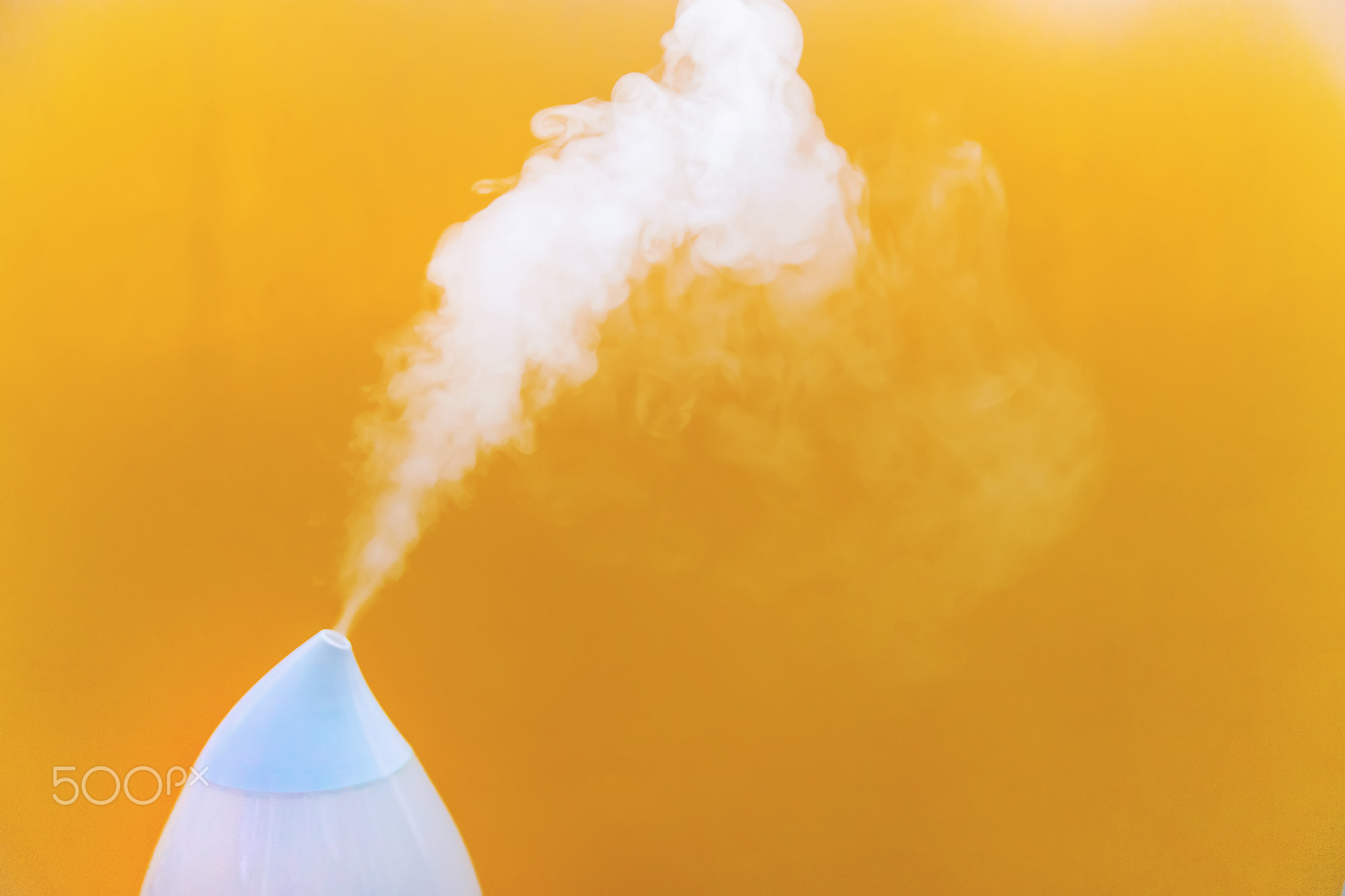 Air humidifier on a yellow background. Selective focus.