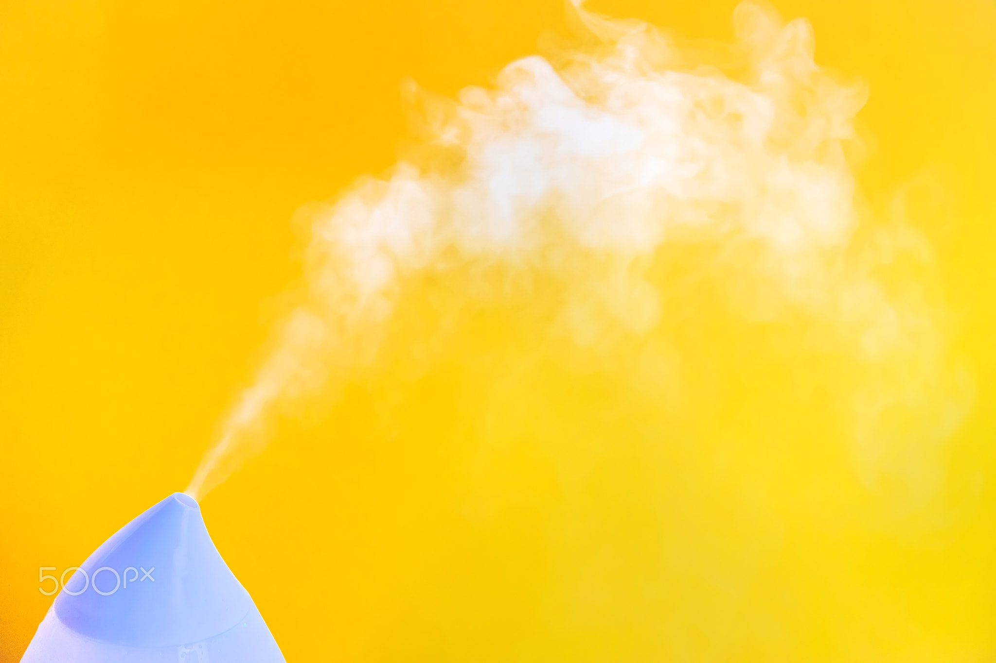 Air humidifier on a yellow background. Selective focus.