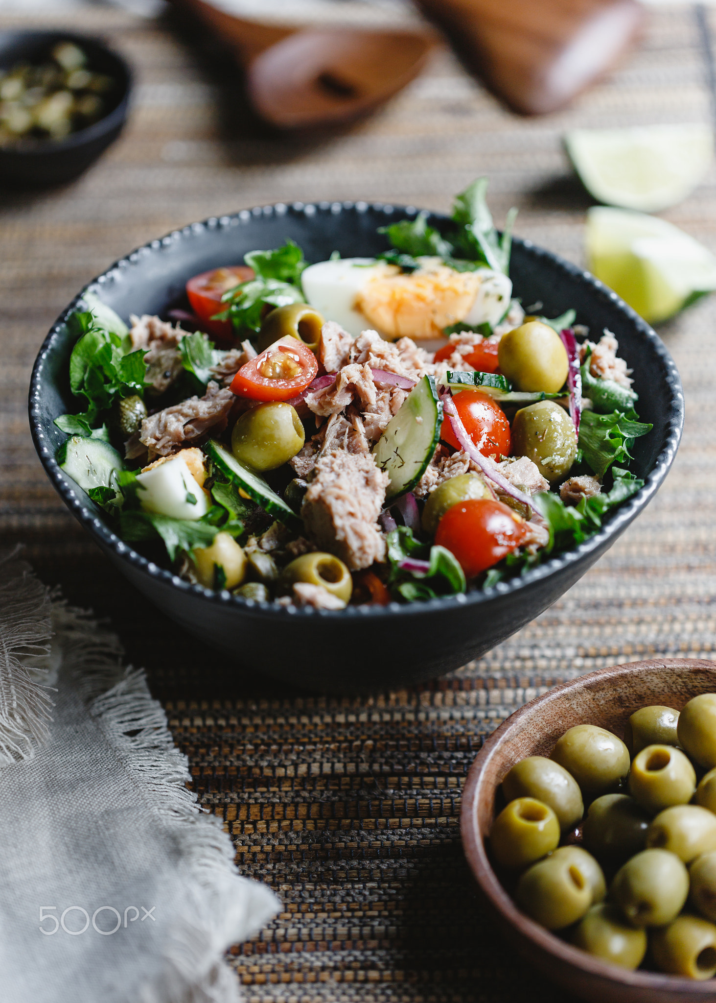 Canned tuna salad with fresh vegetables, capers and olives