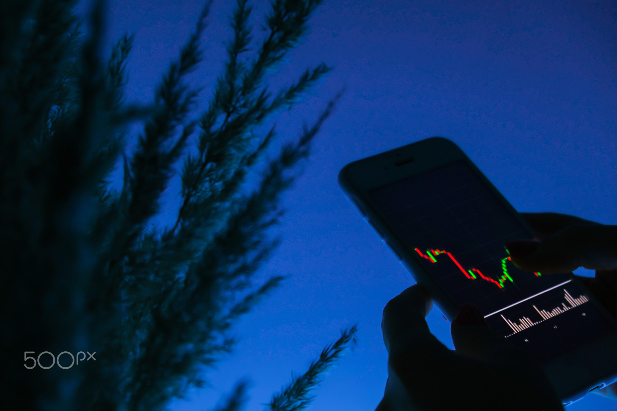 Woman holding mobile phone, block chain with graph of stock market