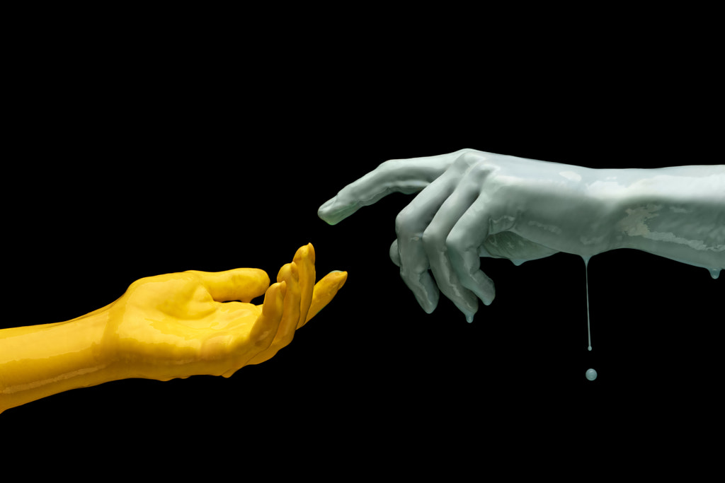 Two painted hands trying to touch each other isolated on dark by Volodymyr Melnyk on 500px.com