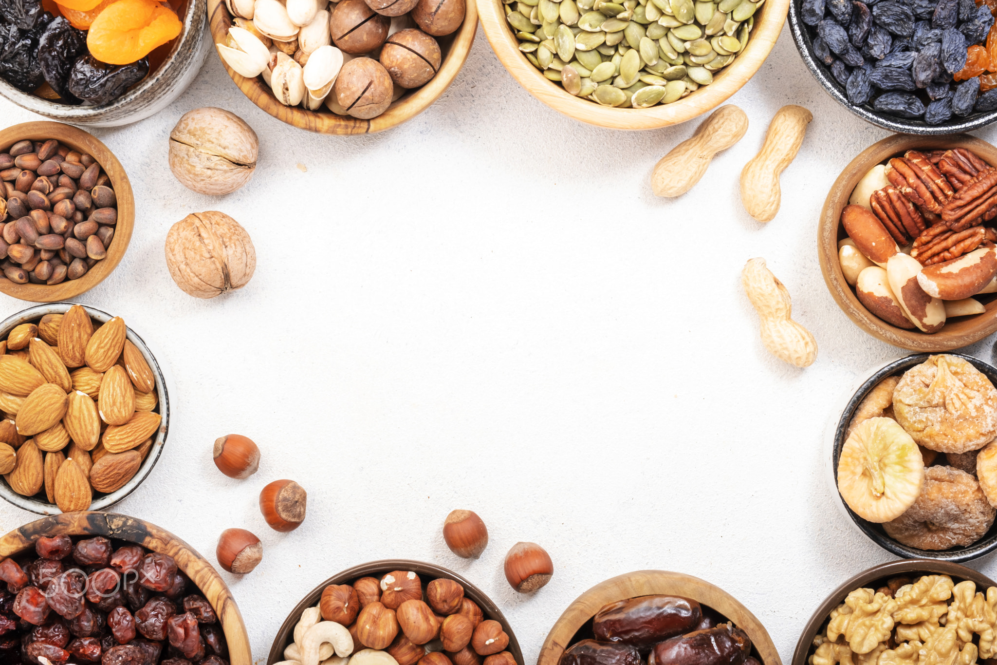 Dried fruits nuts in bowls set.