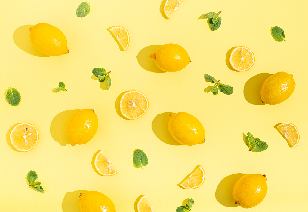 lemons with mint on minimal beige yellow background on bright sun by Elena Yeryomenko on 500px.com
