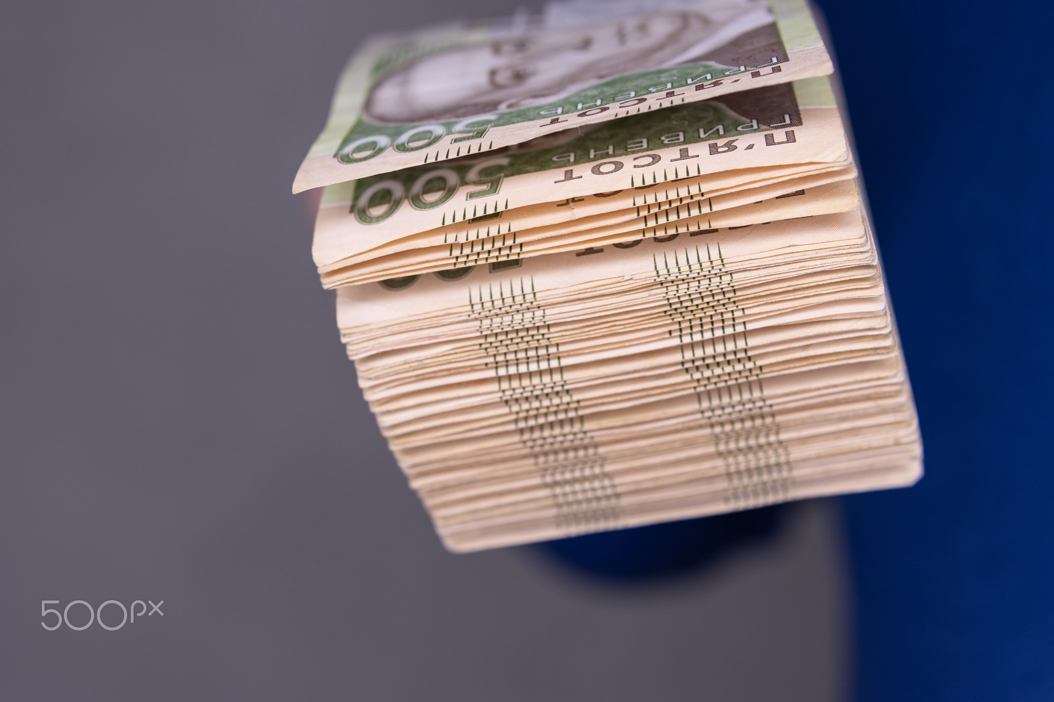 A man holds a stack of new banknotes in his hands 500 hryvnia close-up