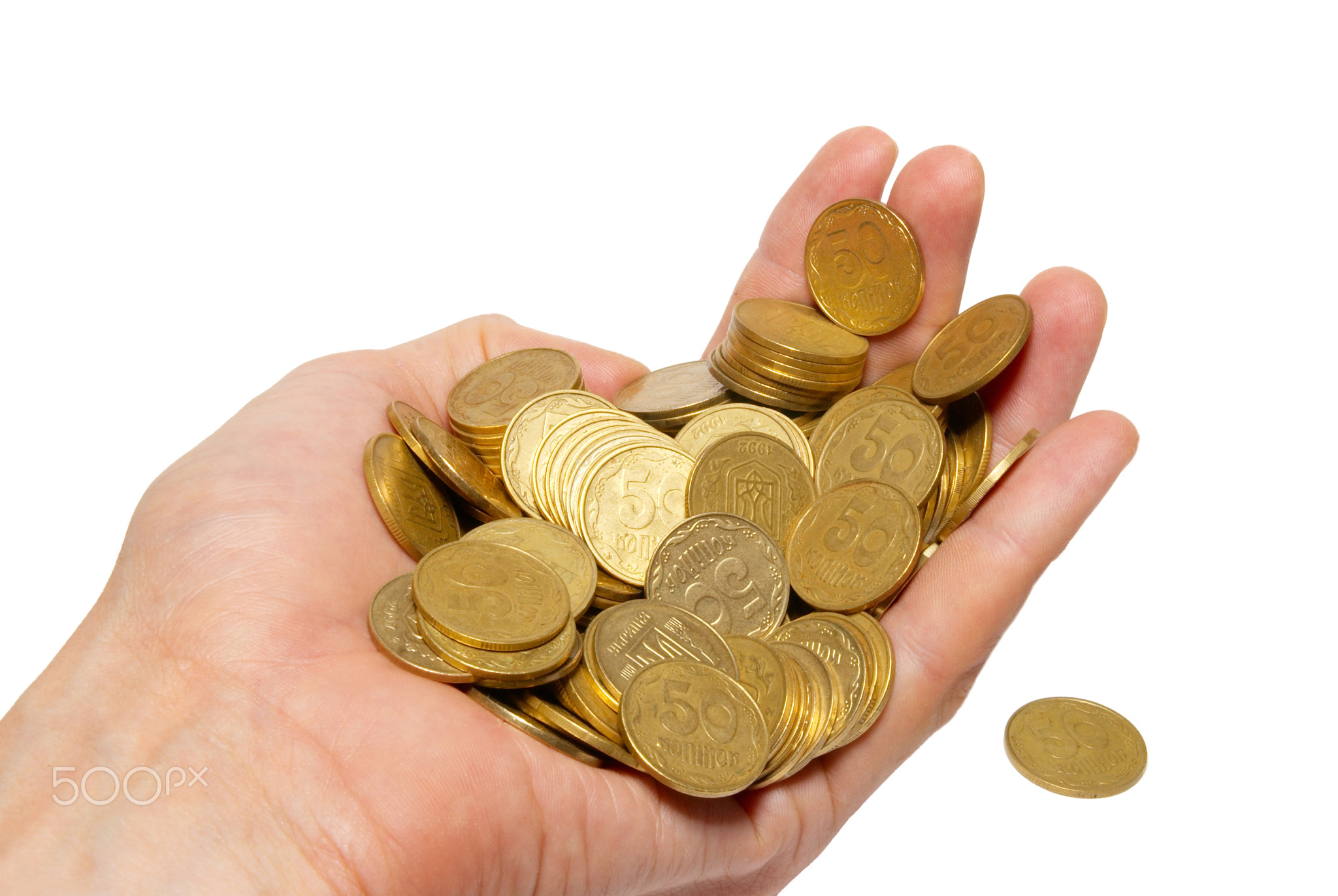 Many coins in a hand isolated on white.