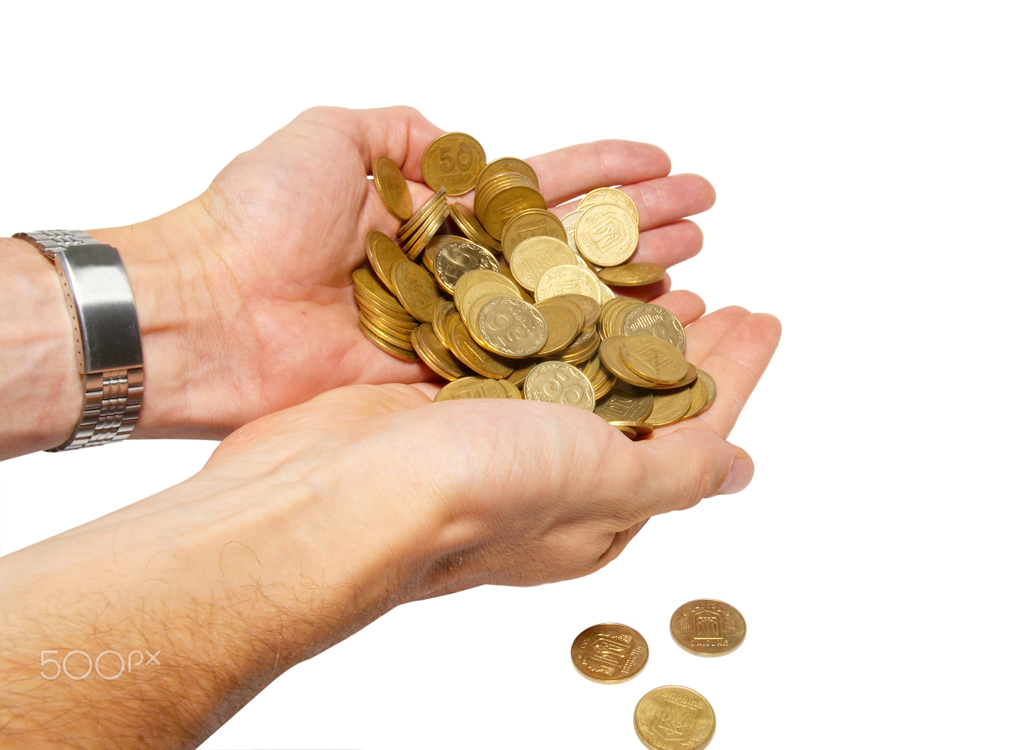 Many coins in cupped hands isolated on white.