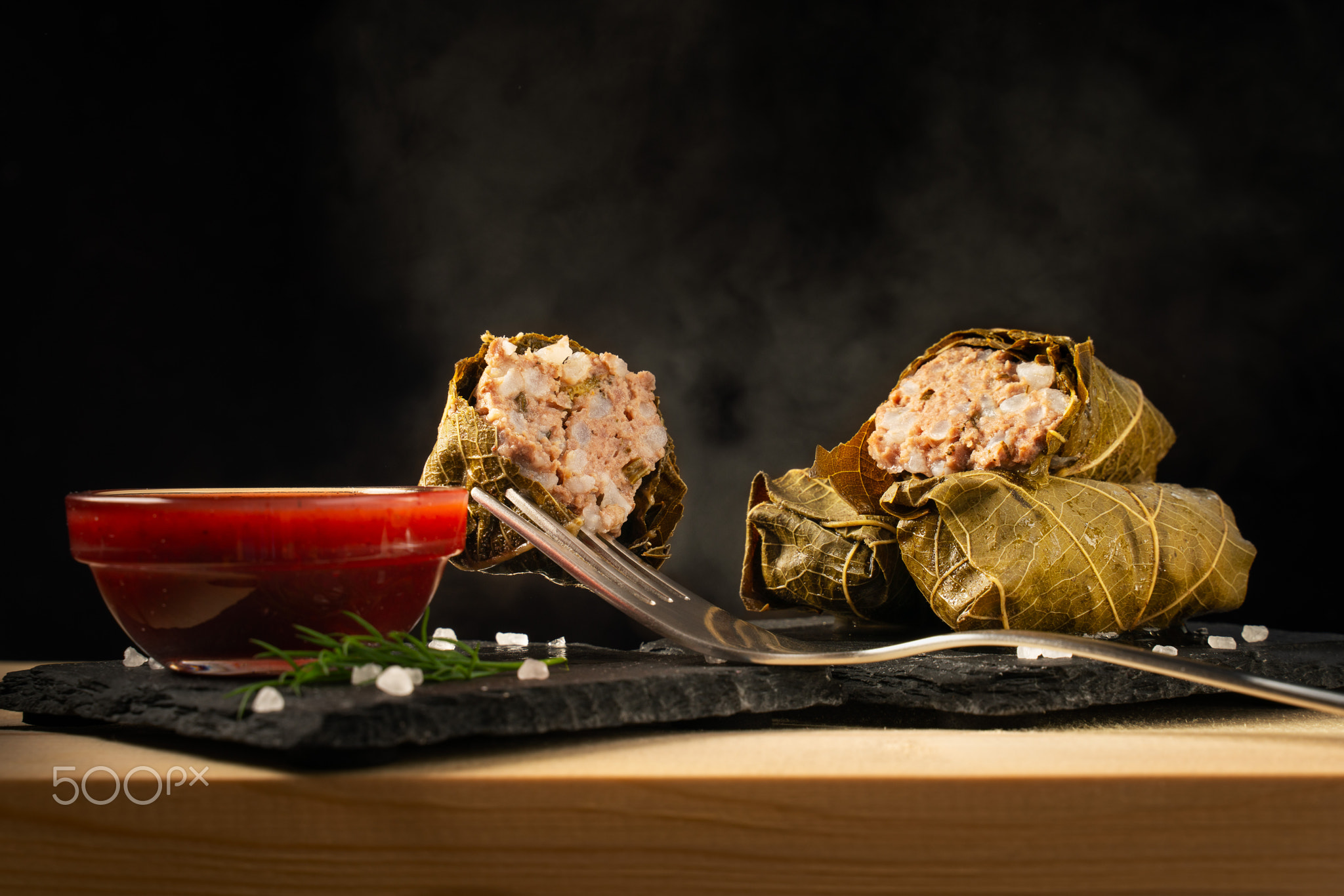 dolma of grape leaves and minced meat on a dark background