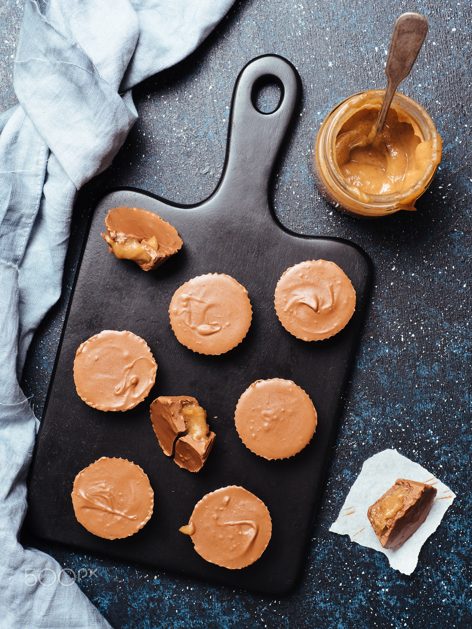 Stack of vegan chocolate cups with caramel on white