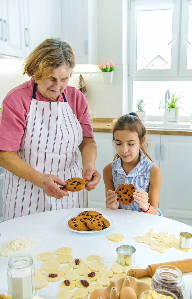 Grandmother and granddaughter are baking cookies in the kitchen by Yana Tatevosian on 500px.com
