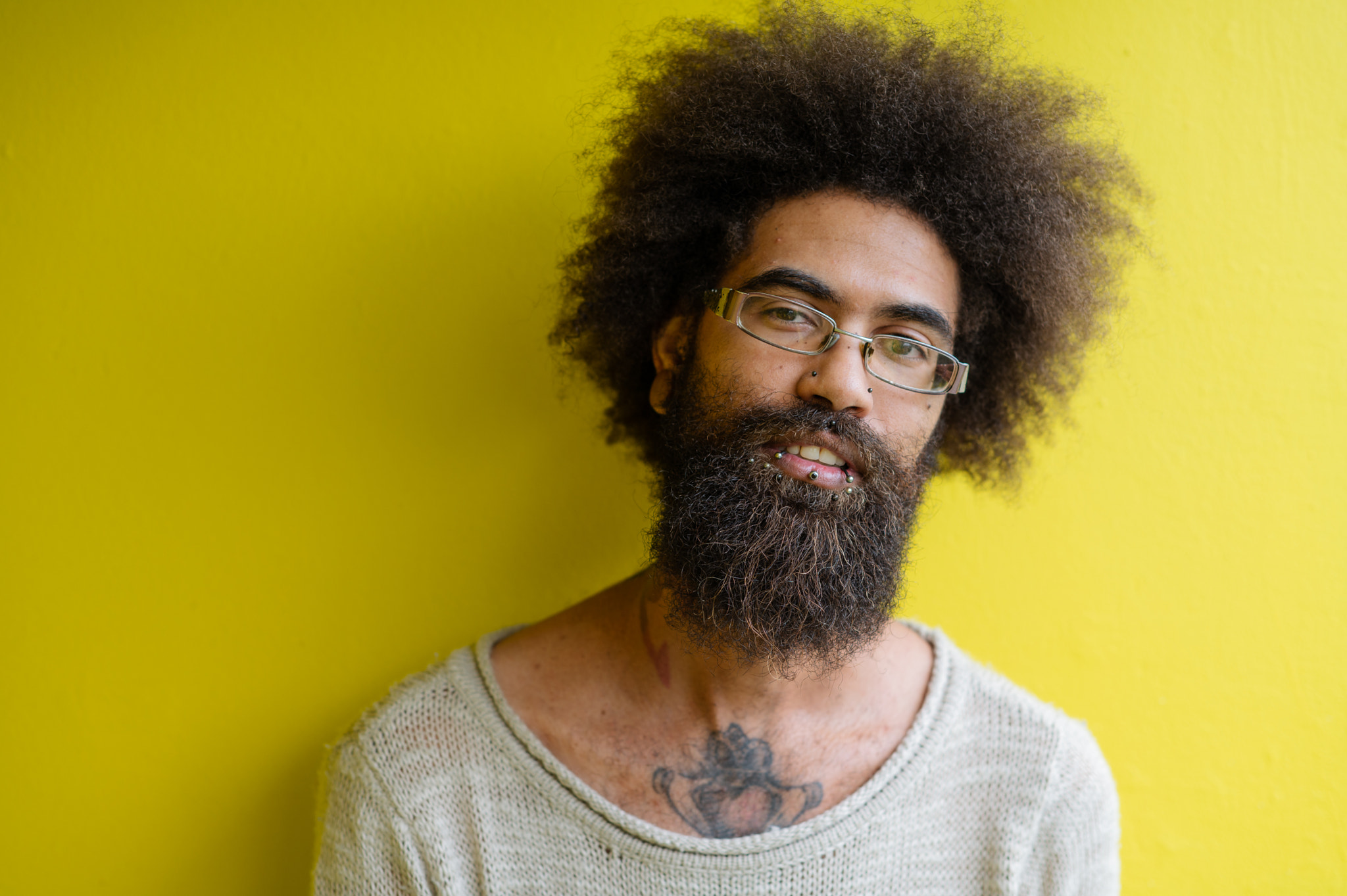 Close up portrait of bearded man with piercings and a afro