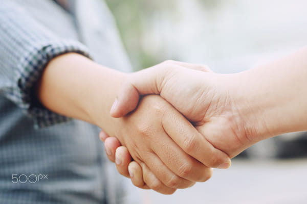 Closeup of a business hand shake between two colleagues Plaid shirt by boytaro Thongbun on 500px.com