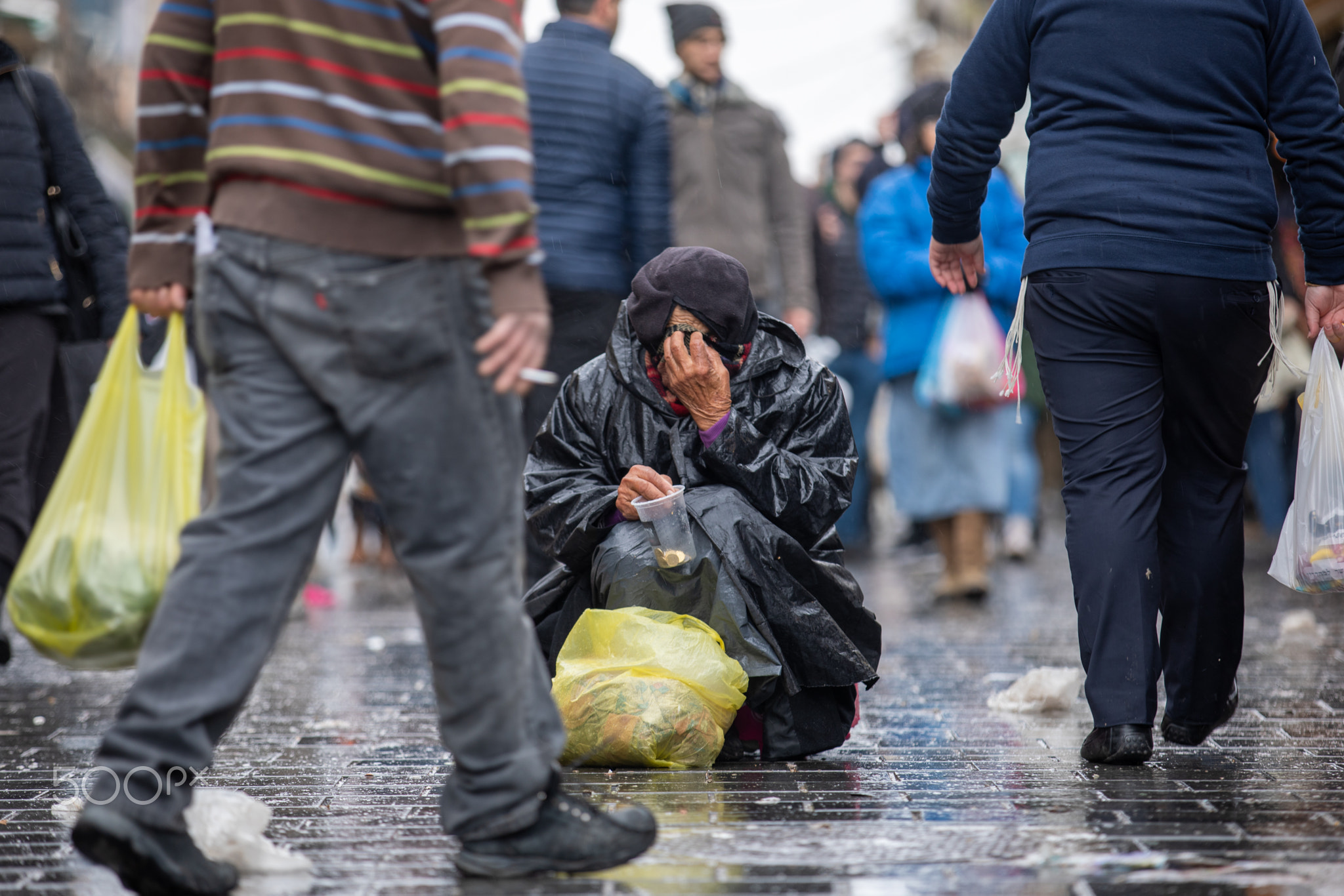 man holding a glass jar for donations