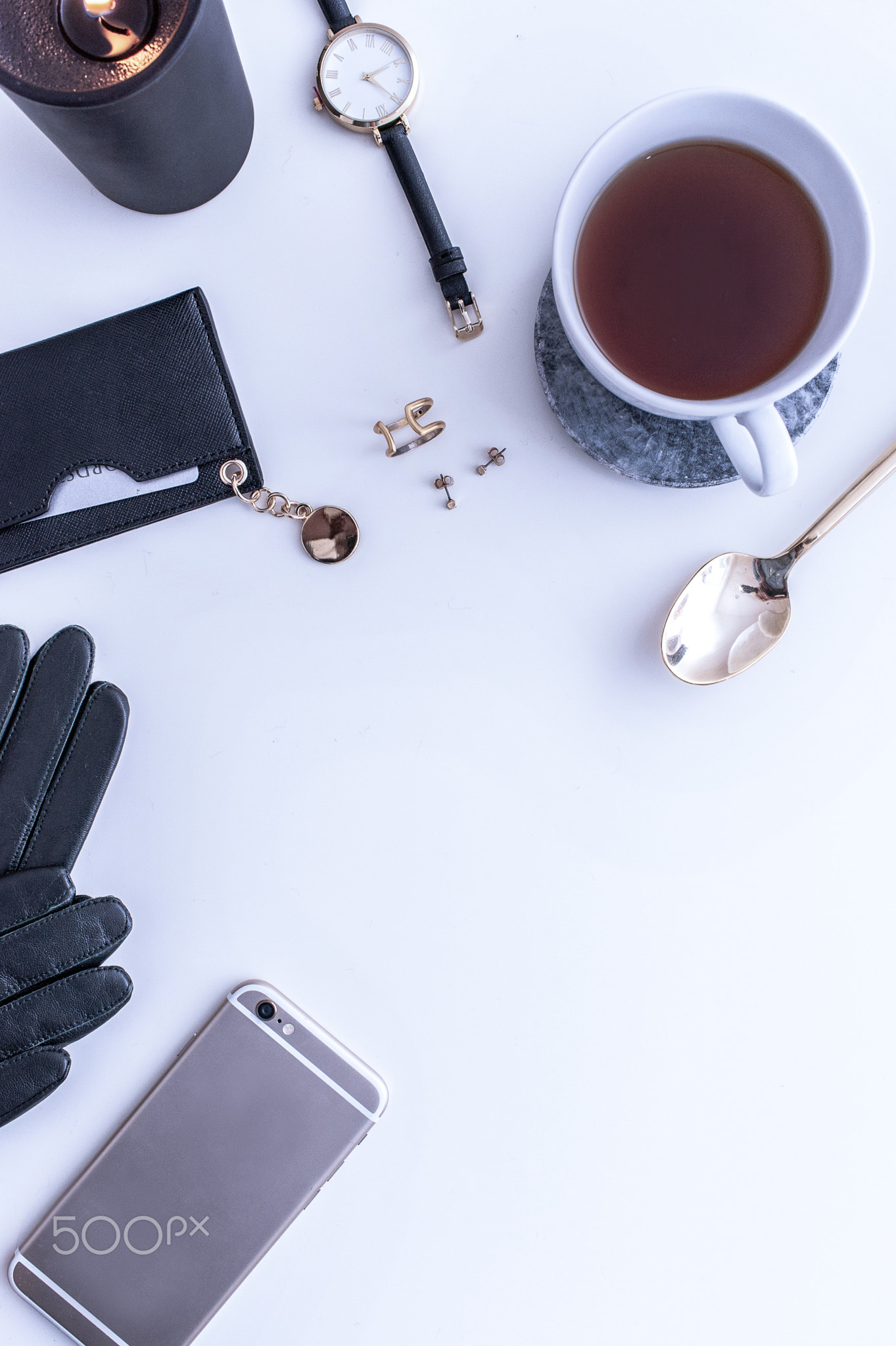 A white mug with black coffee on a white countertop. There are white