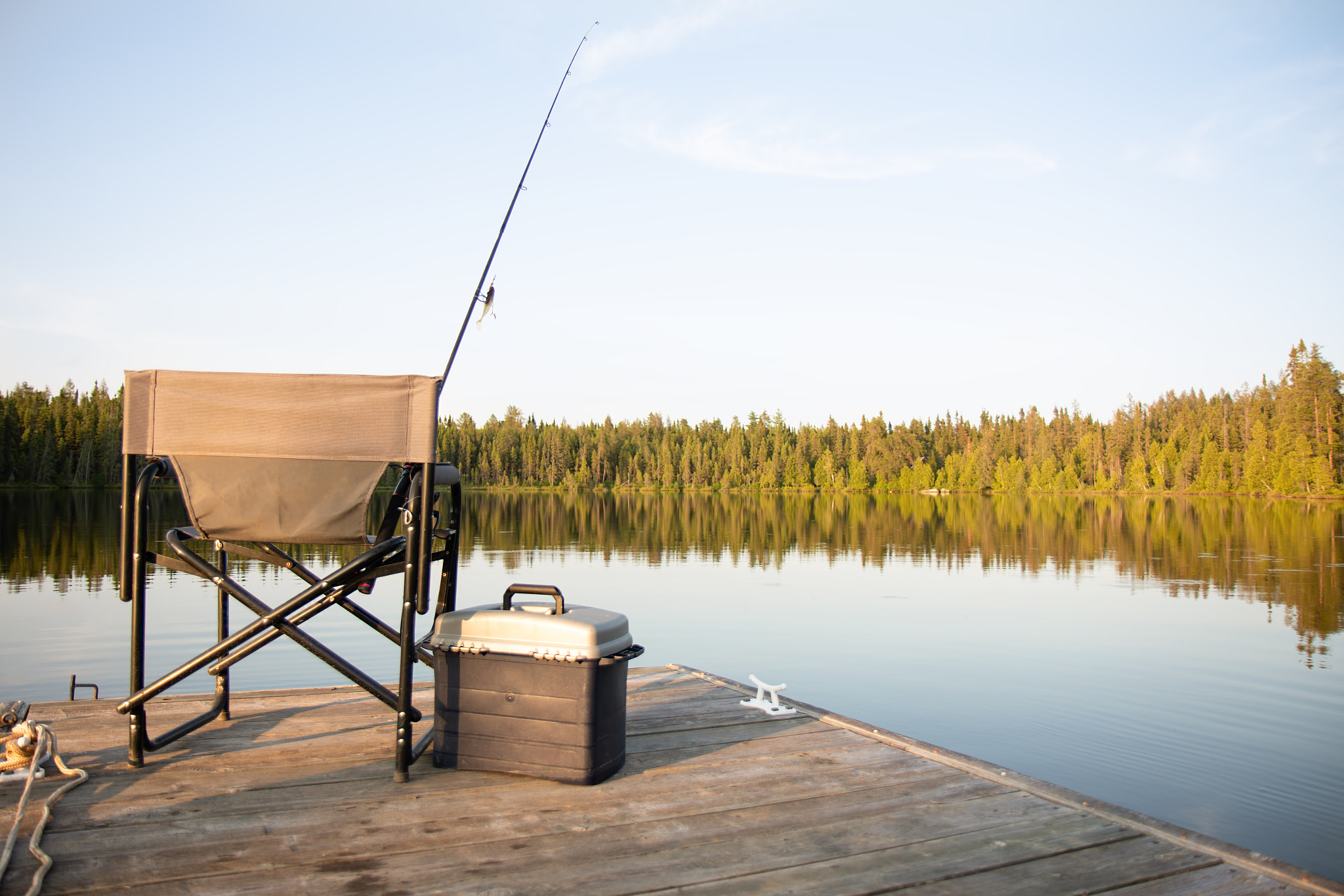 A Chair on a Wooden Dock Looking Out on a Lake in Summer