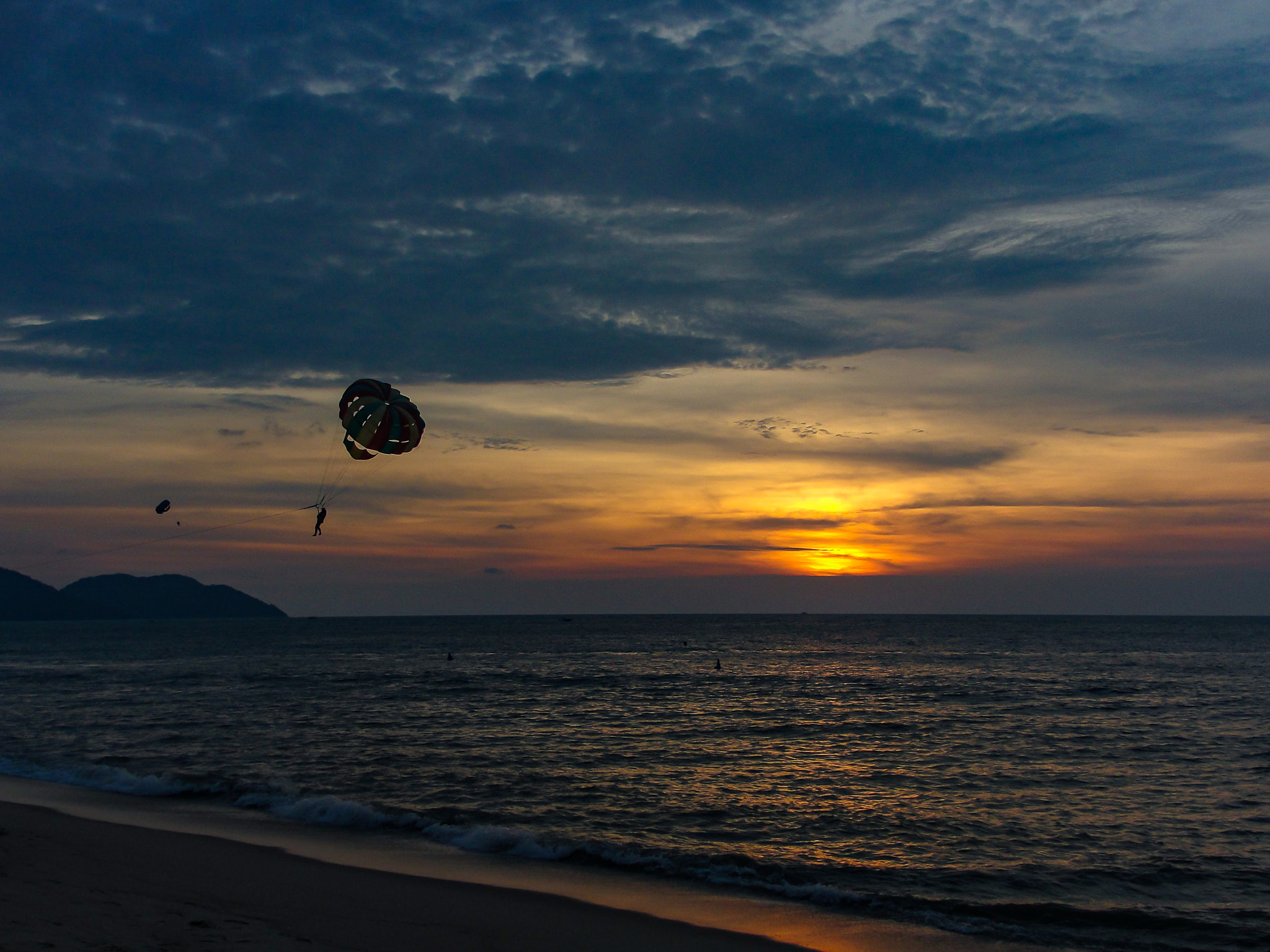 Parachute against sunset and sea, Batu Ferringhi, Penang, Malaysia