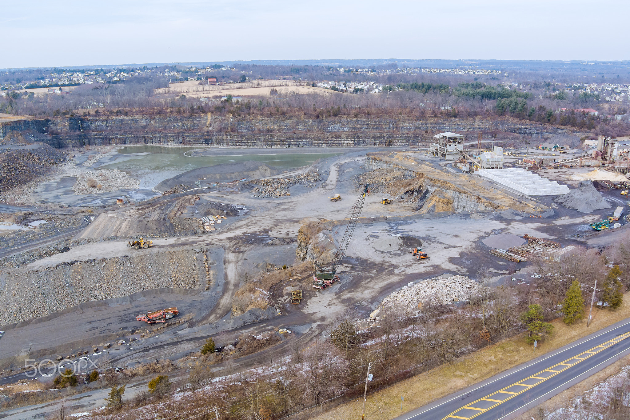 Aerial view of the open pit loader loading gravel into stone jaw