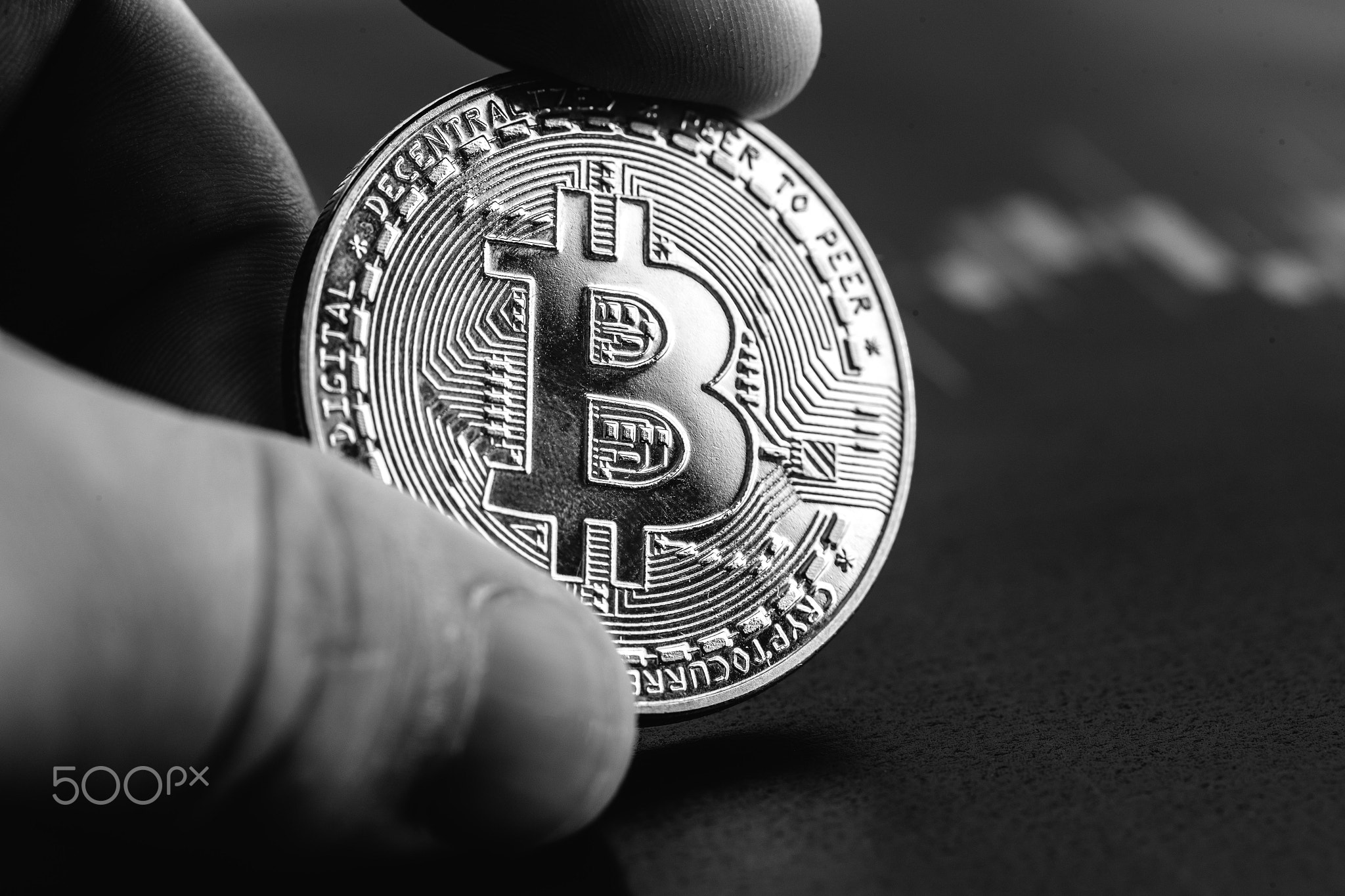 Bitcoin in hands close-up. Cryptocurrency rate.