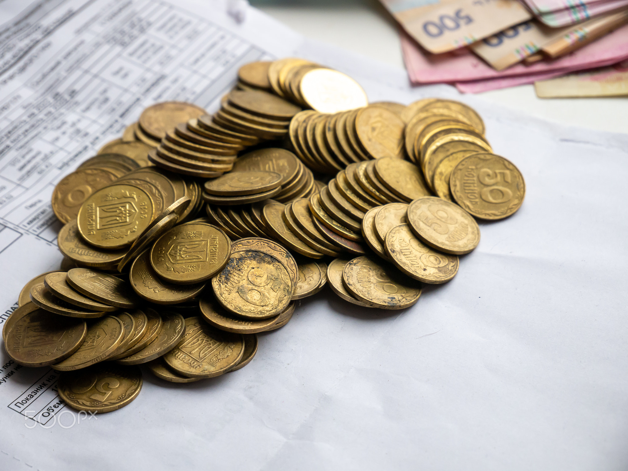 Ukrainian coins lie in a pile on documents