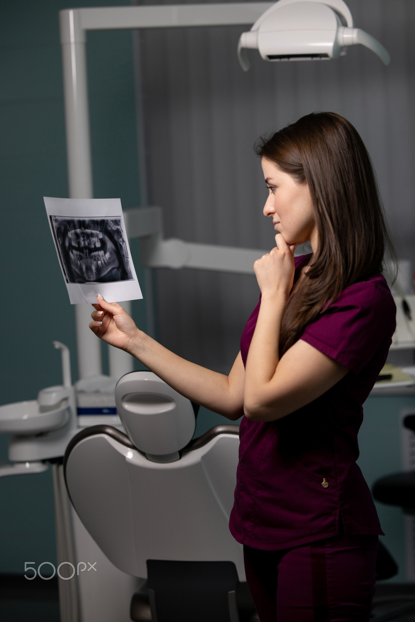 Beautiful woman doctor with dental scans in hands in a dental clinic