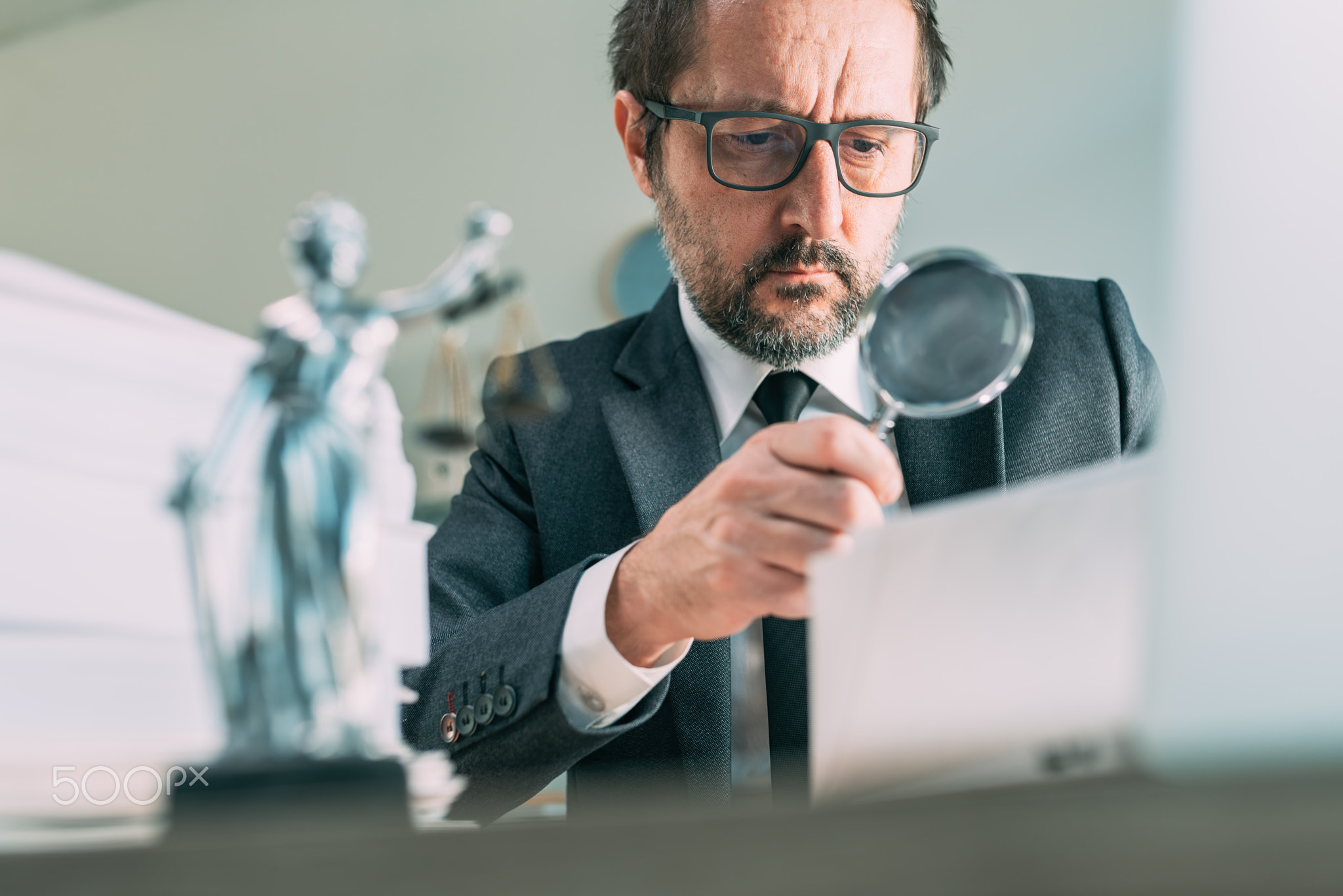 Lawyer reading legal contract agreement in law practice office