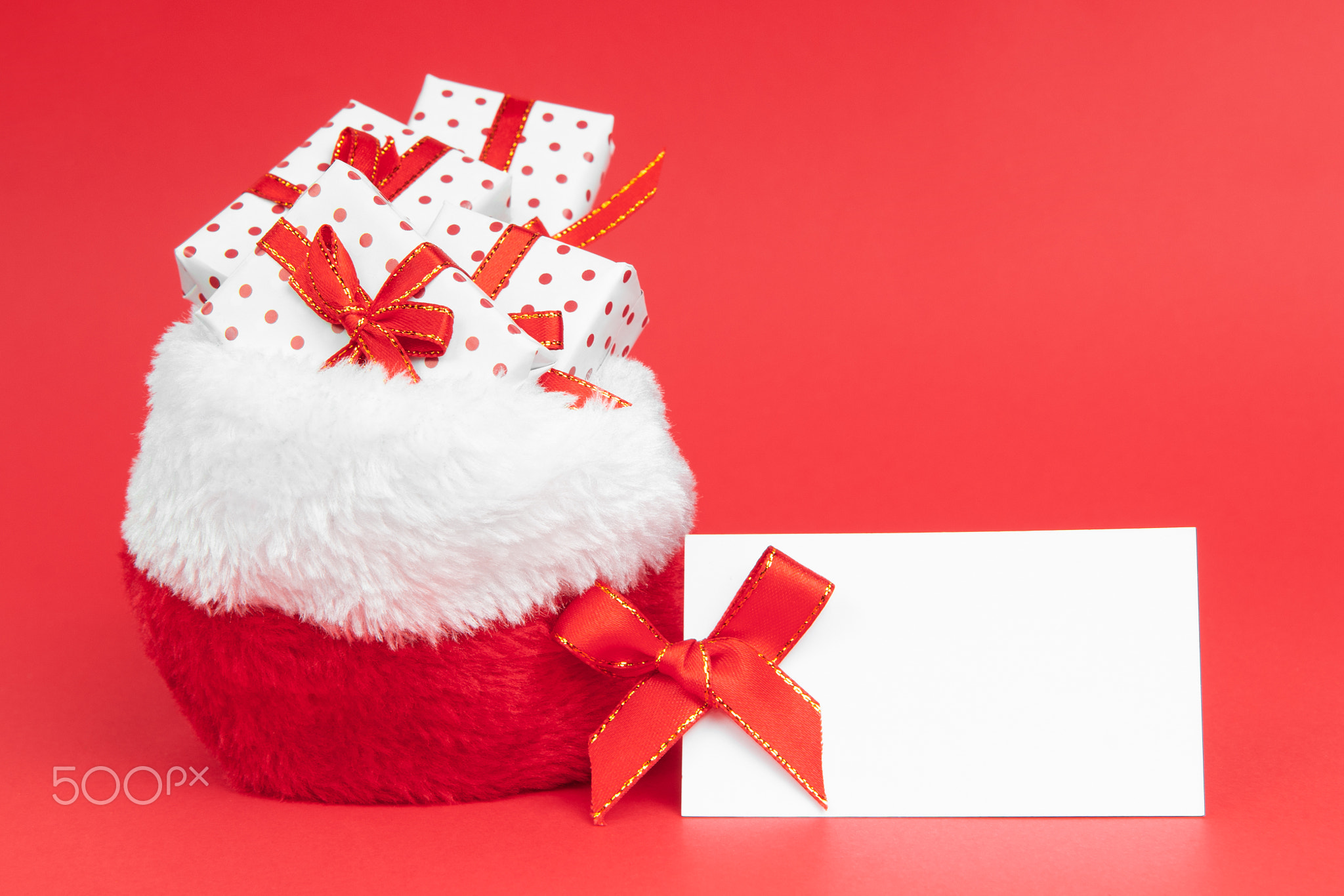 Heaps of christmas gifts in Santa Claus sack wrapped in gift paper