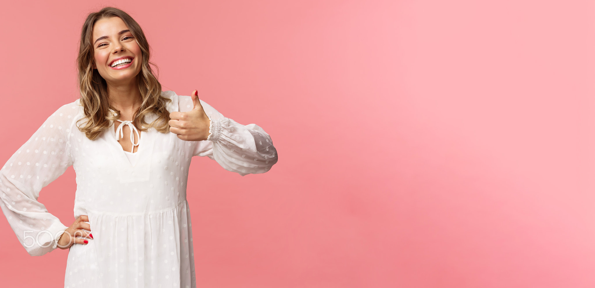 Enthusiastic lovely young woman in white cute dress, show thumb-up in