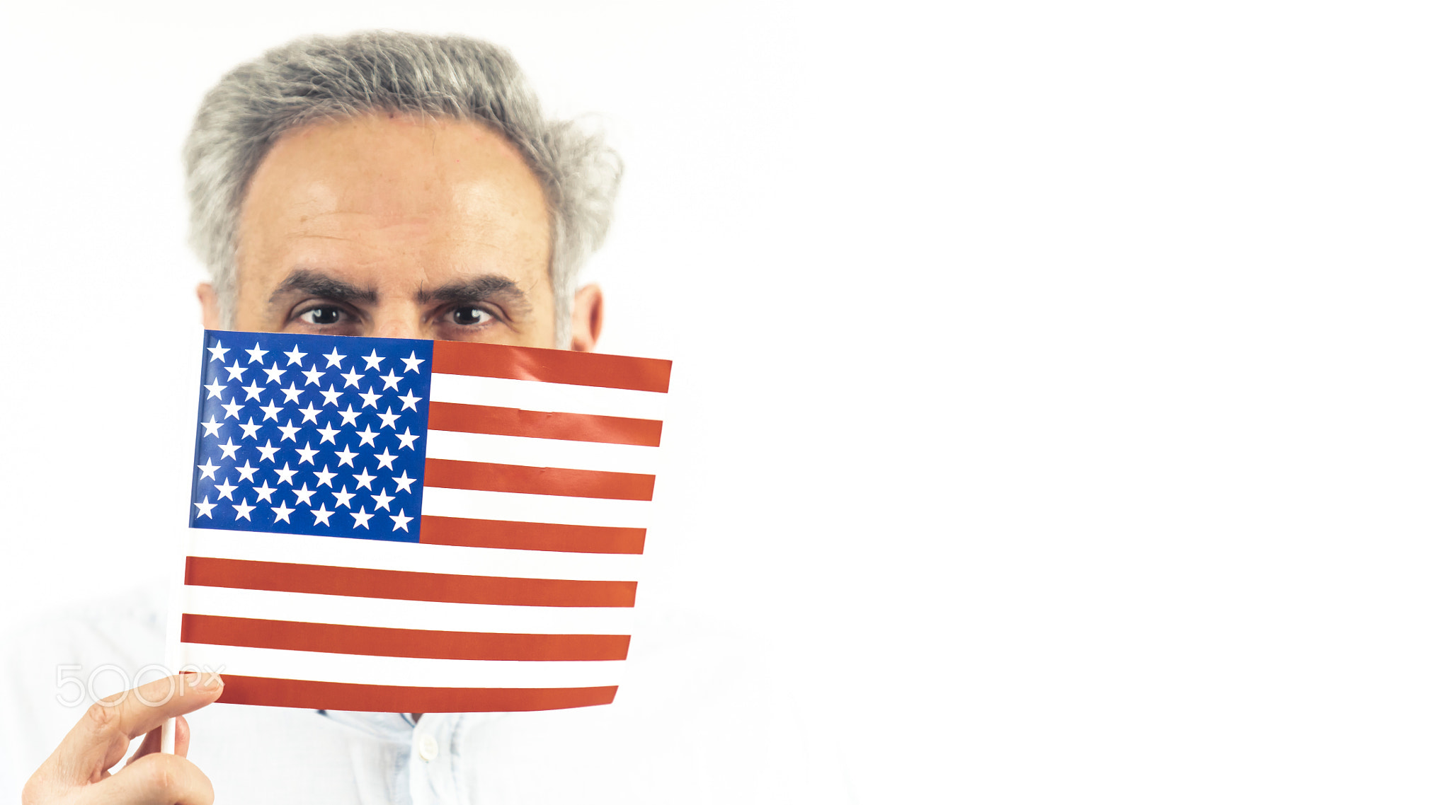 40s caucasian man hiding behing the US flag - portrait isolated on