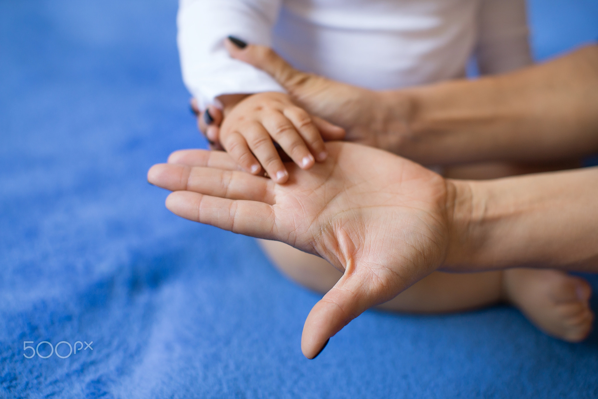 Children's hand on the palm of a woman