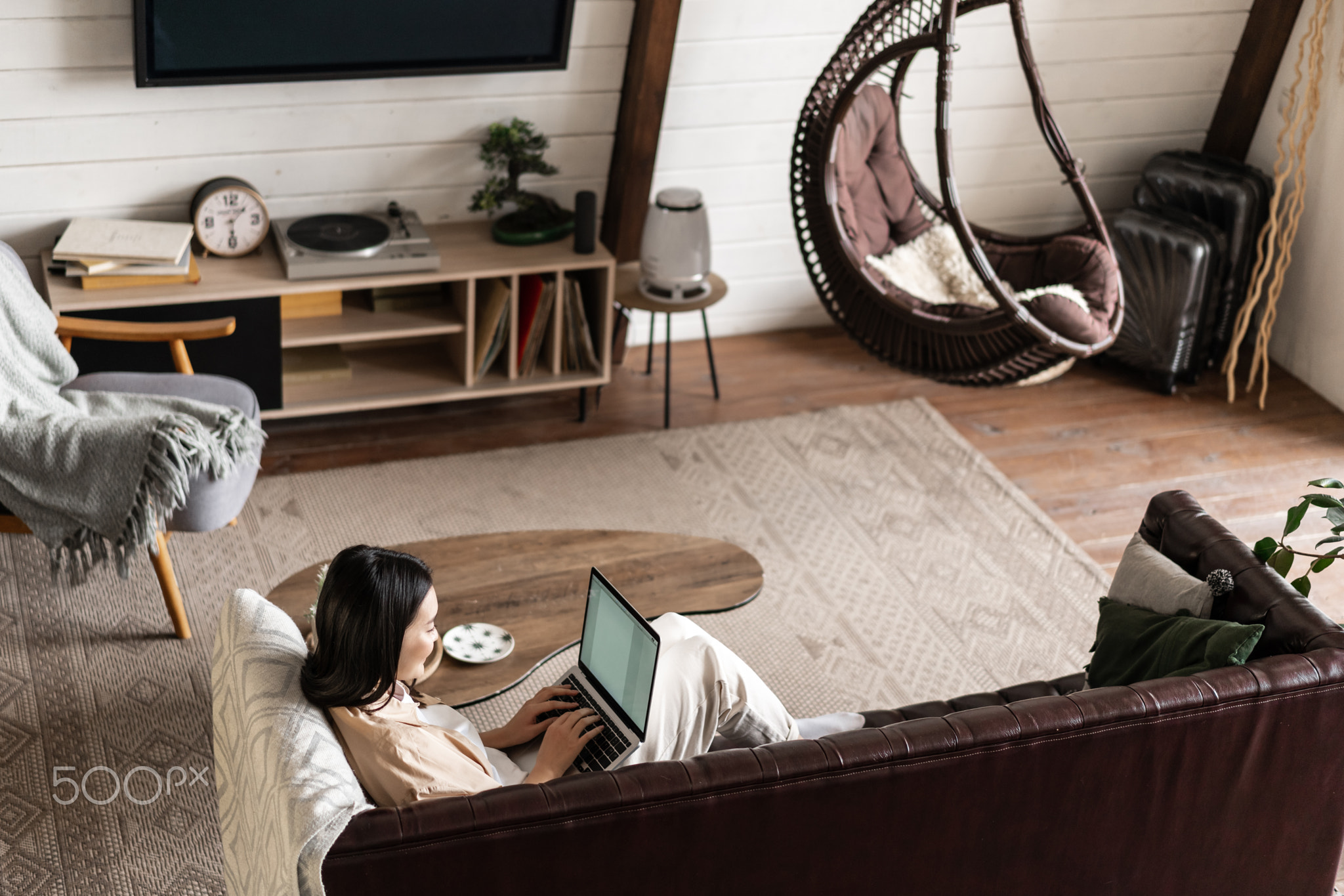 Portrait of asian woman working from home on laptop computer, sitting