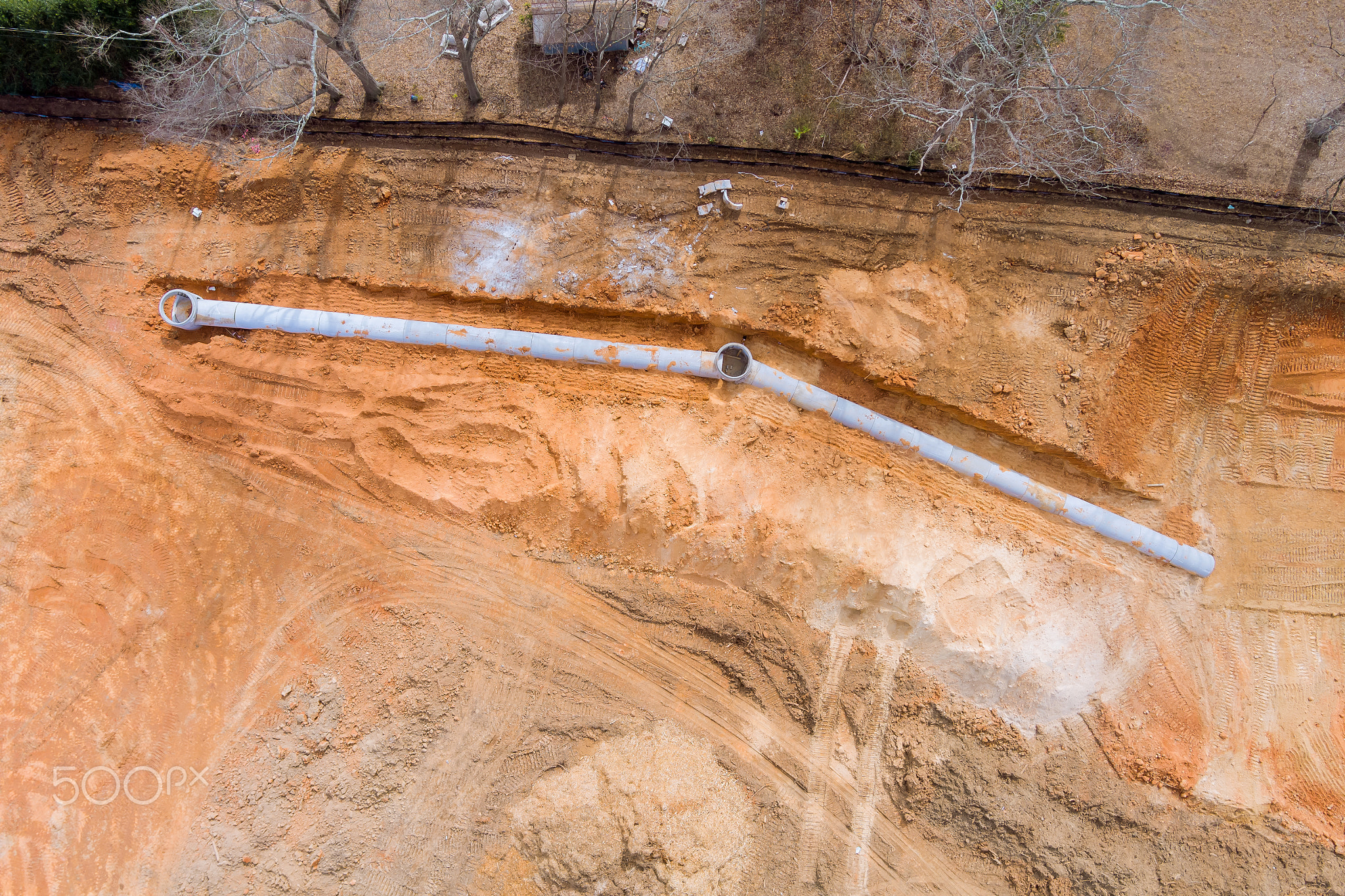 Aerial top layer pipes installation of underground utilities on