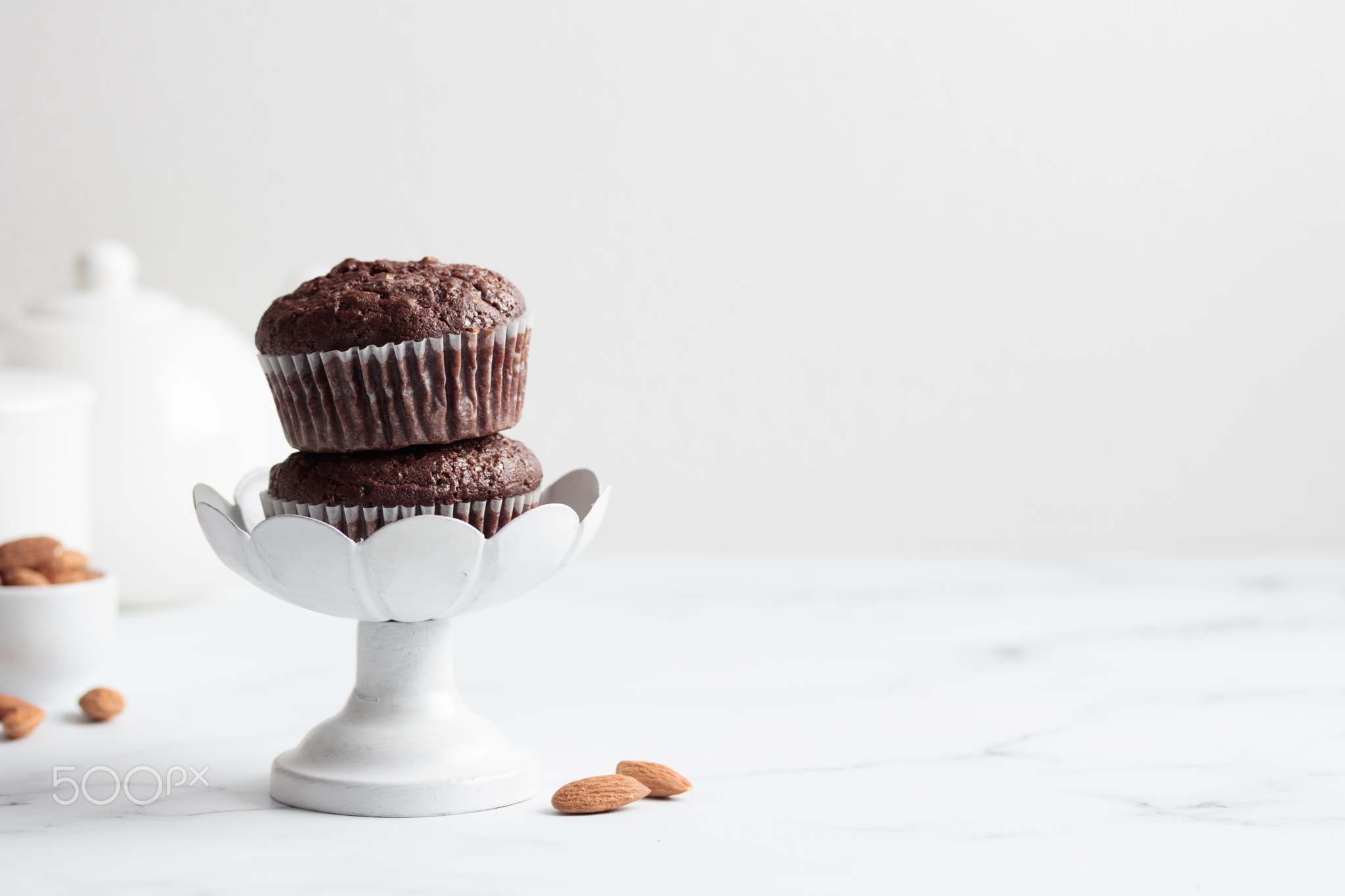 Chocolate muffins in a white cake stand