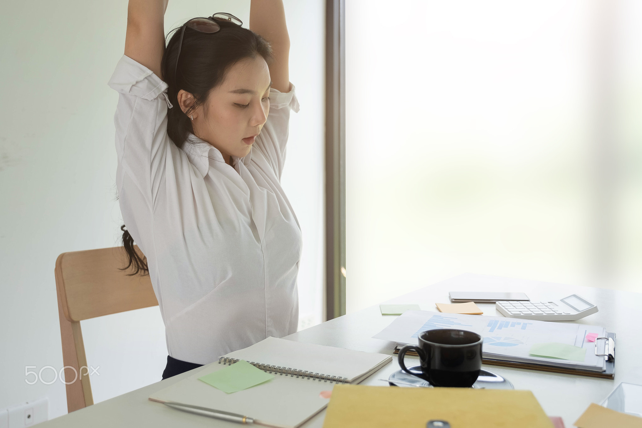 Businesswoman relaxing at comfortable in office hands behind head