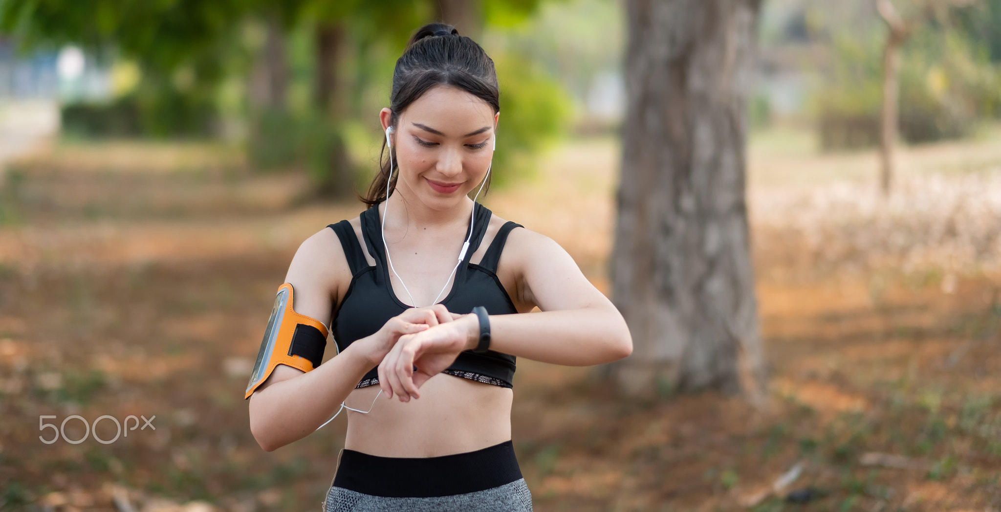 Young woman workout at outdoor using smart watch healthy lifestyle.