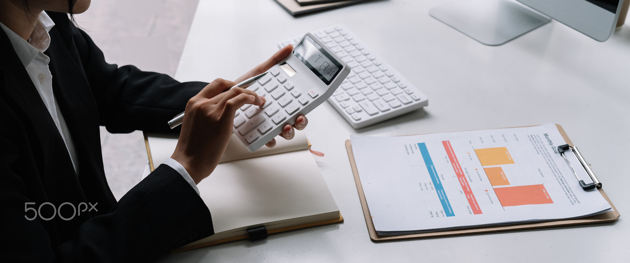 Close up of businessman or accountant hand holding pen working on