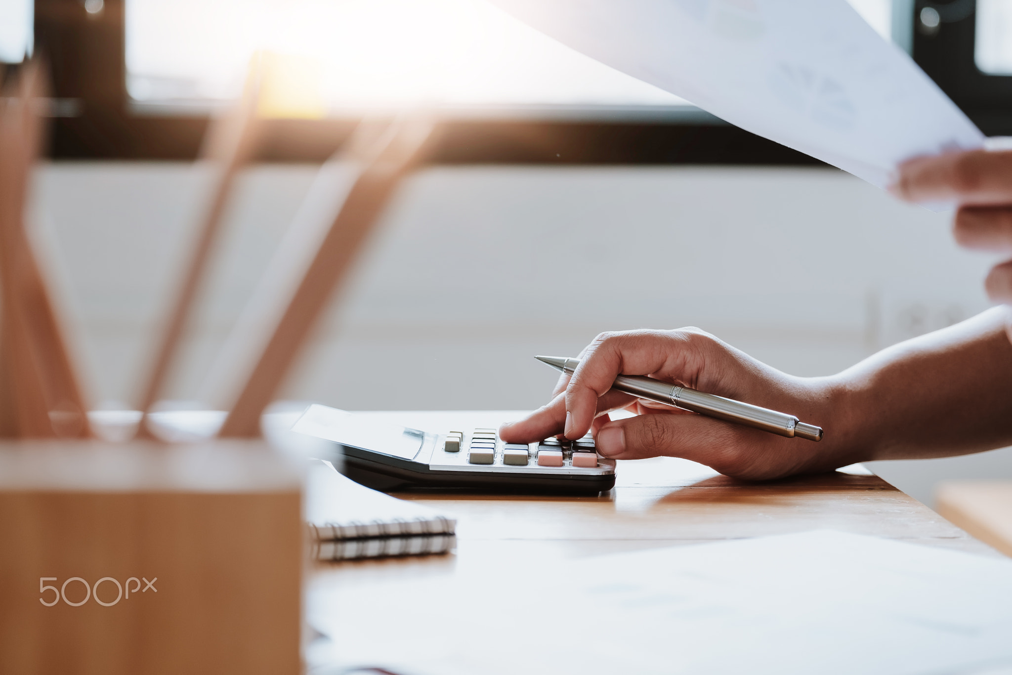Close up Business woman using calculator and laptop for do math