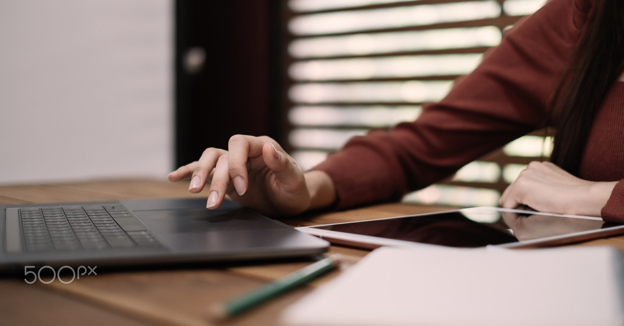 Close up of woman hands using on laptop computer for online learning