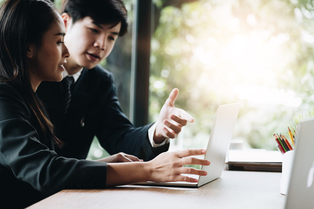 Young Business People Executive Analyzing Statistics Business by Natee Meepian on 500px.com